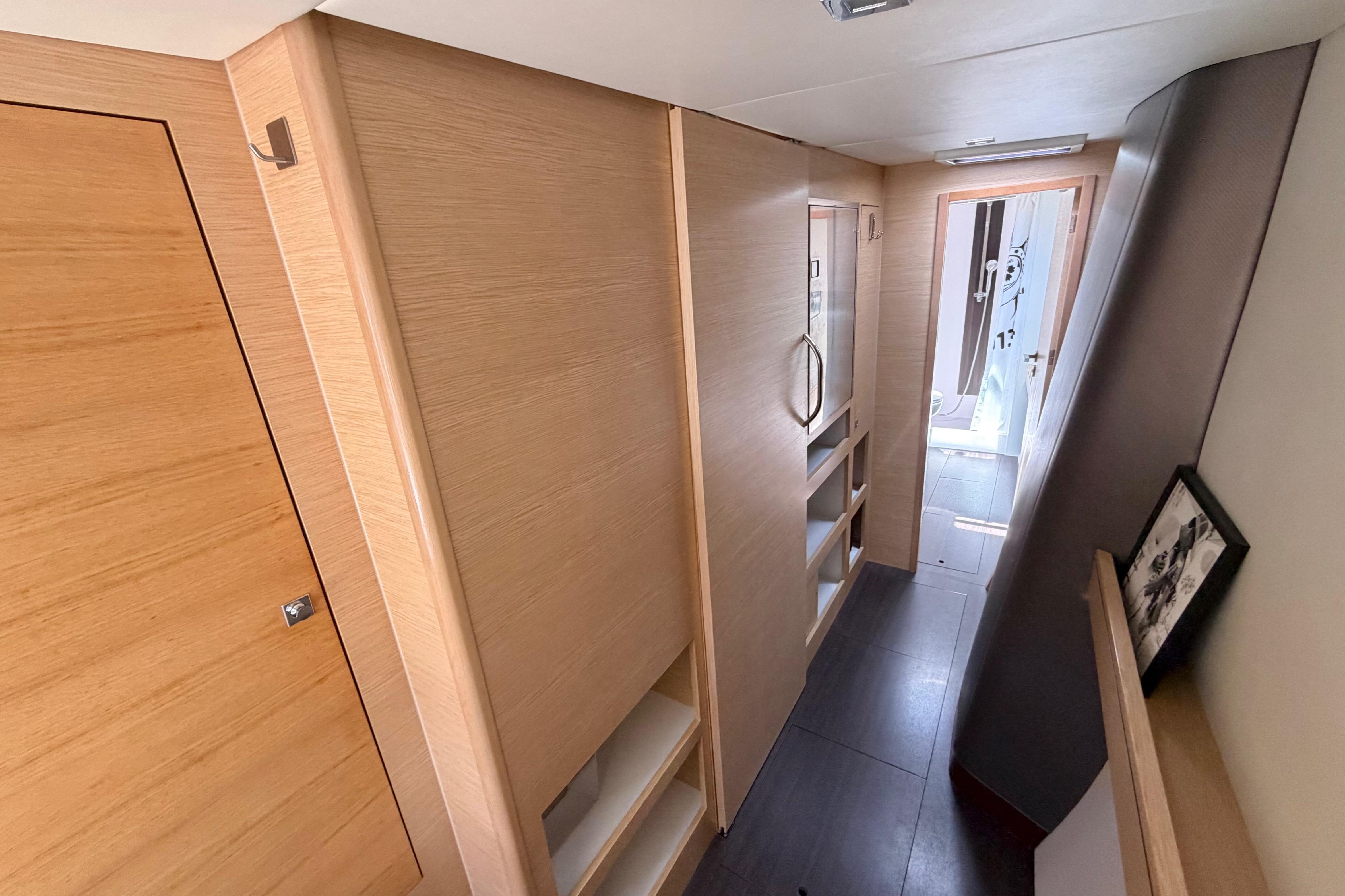 Interior hallway of 2016 Outremer 45 yacht, featuring sleek wooden cabinetry and modern design.
