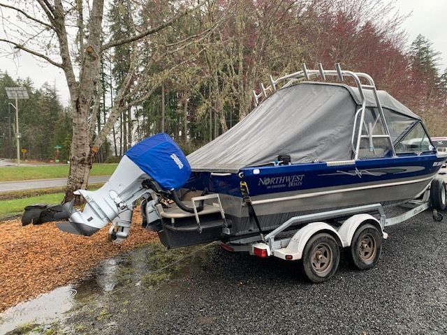 2013 Northwest Boats 196 Freedom on trailer, covered, parked outdoors.