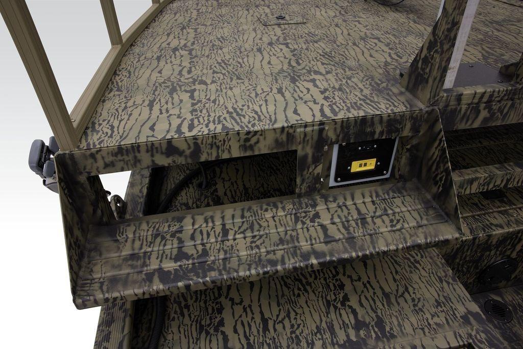 Camouflage-patterned deck of 2026 Tracker GRIZZLY® 2072 CC Sportsman boat, featuring control panel.