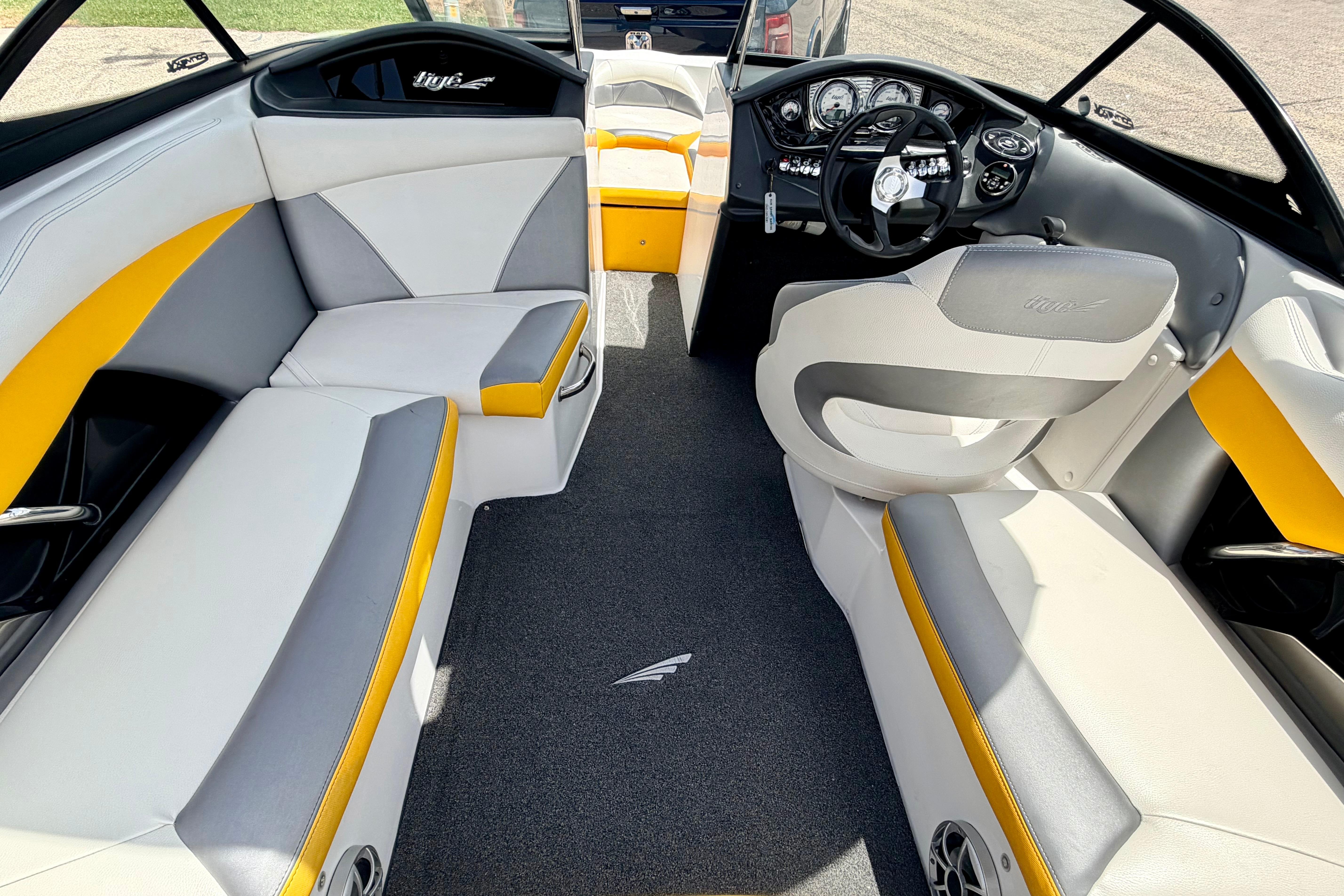 2014 Tigé R20 boat interior with gray and yellow seating, modern dashboard, and steering wheel.