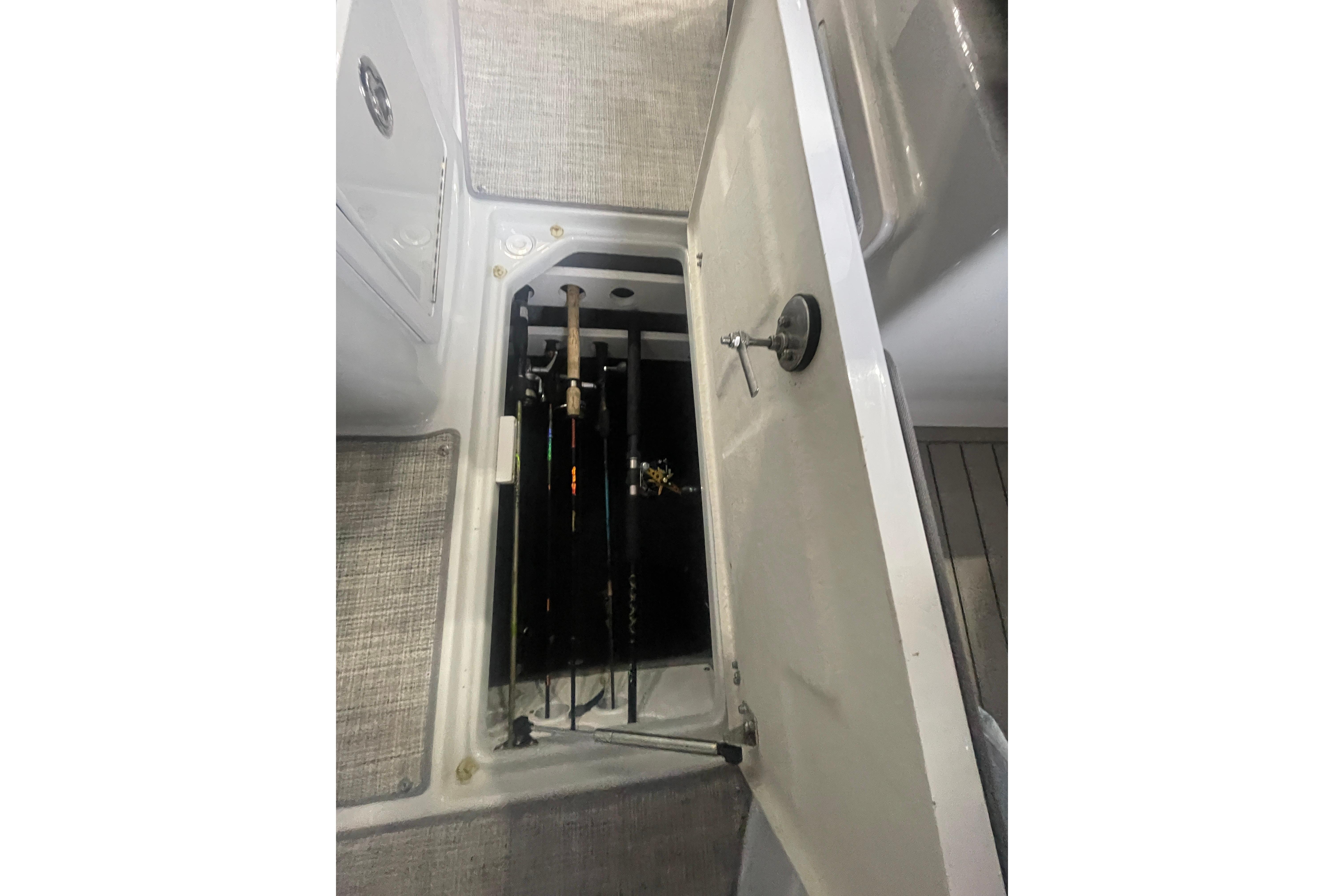2022 Finseeker 280 DC boat rod storage compartment with fishing rods.