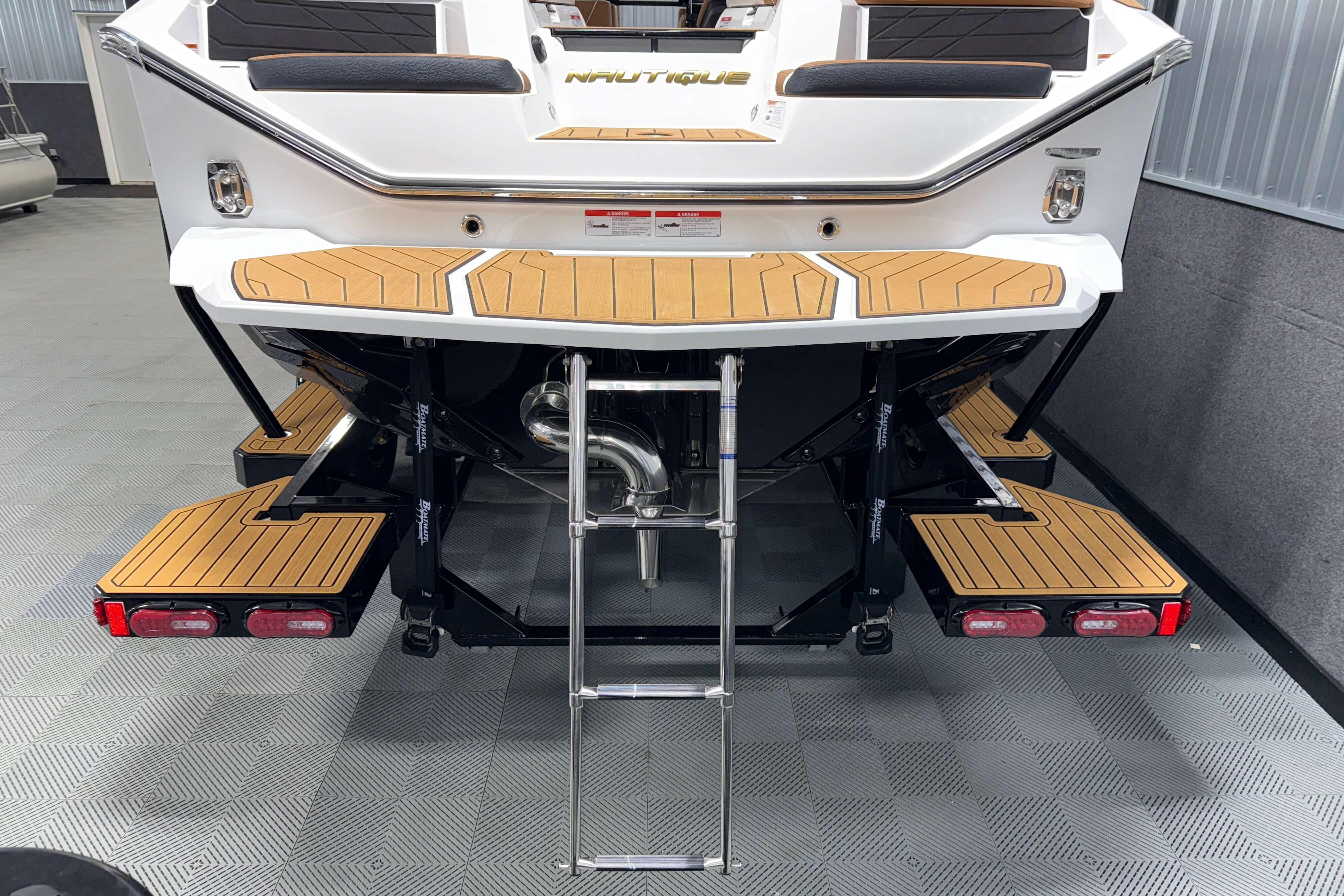 2026 Nautique Super Air Nautique S23 boat with teak swim platform and ladder.