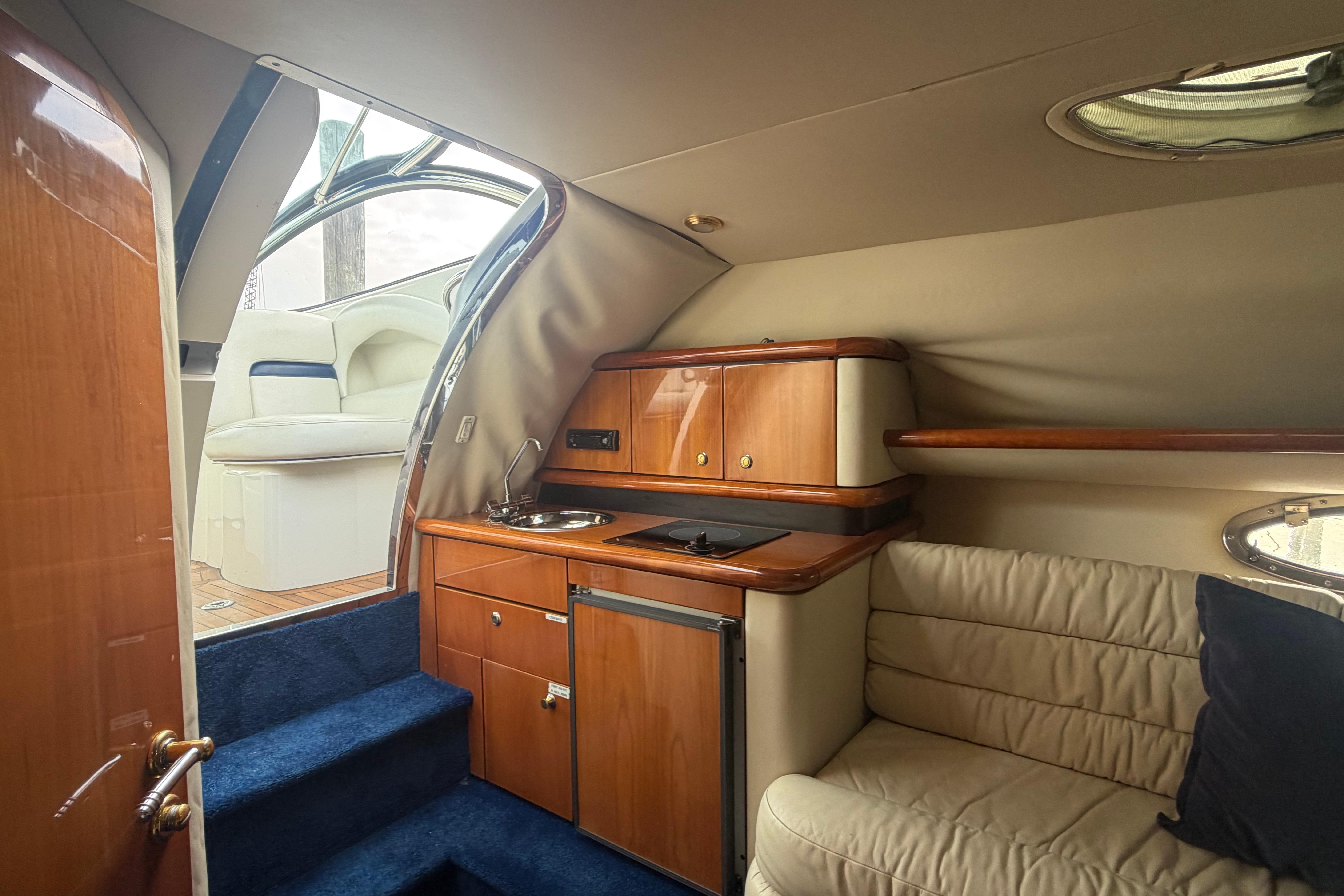 Interior of 2000 Sunseeker Superhawk 34 yacht with kitchenette and seating area.