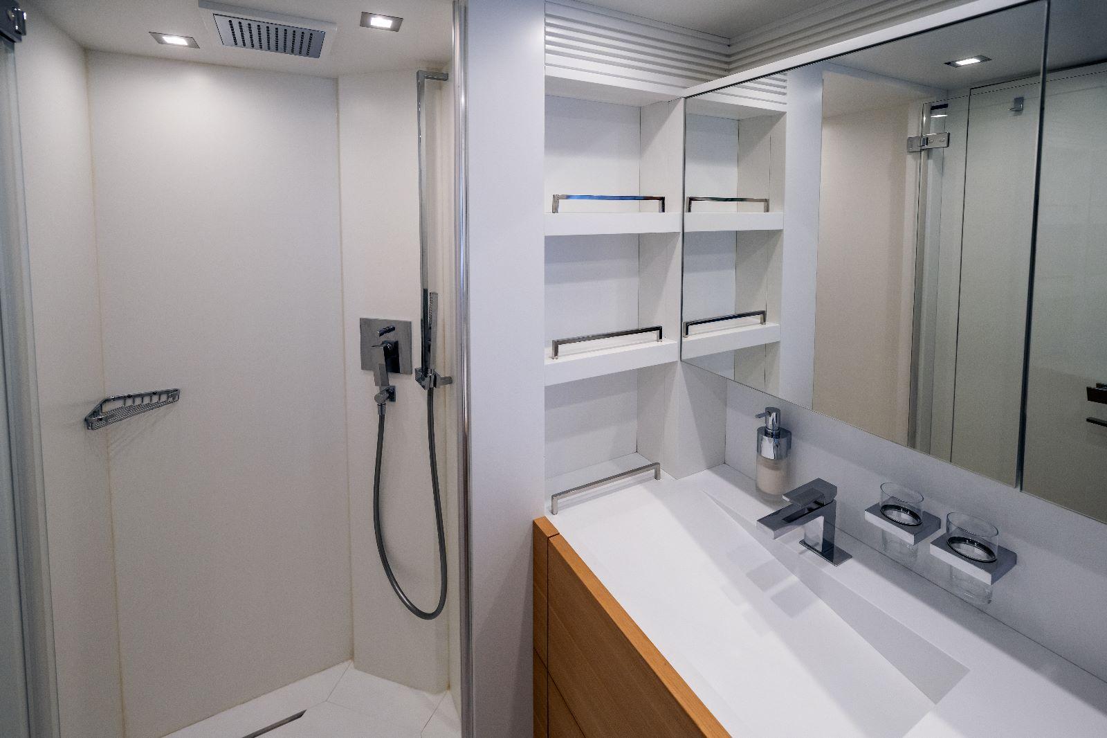 Luxurious bathroom in 2011 Maiora 27 yacht with modern shower and sleek vanity.