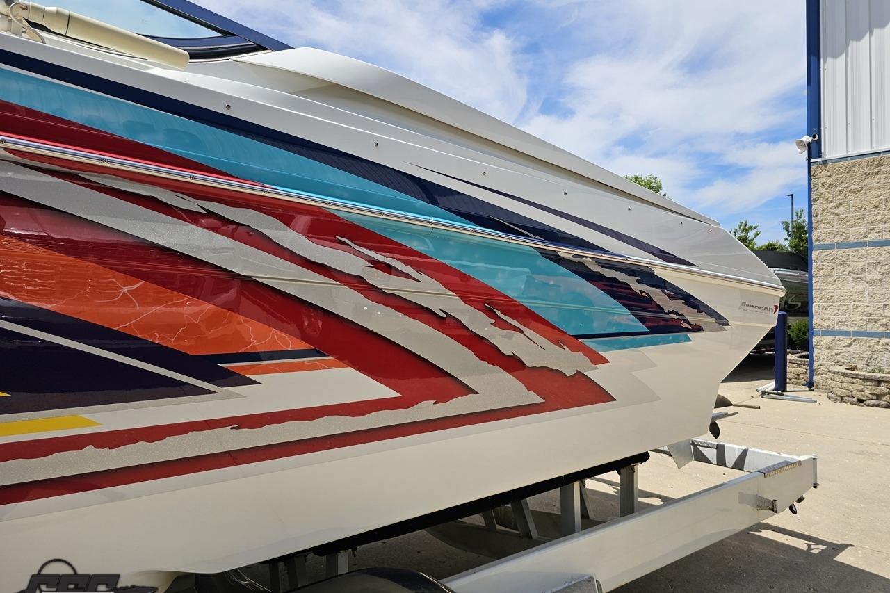 2002 Formula 382 FASTech boat with vibrant, colorful graphics on the hull.