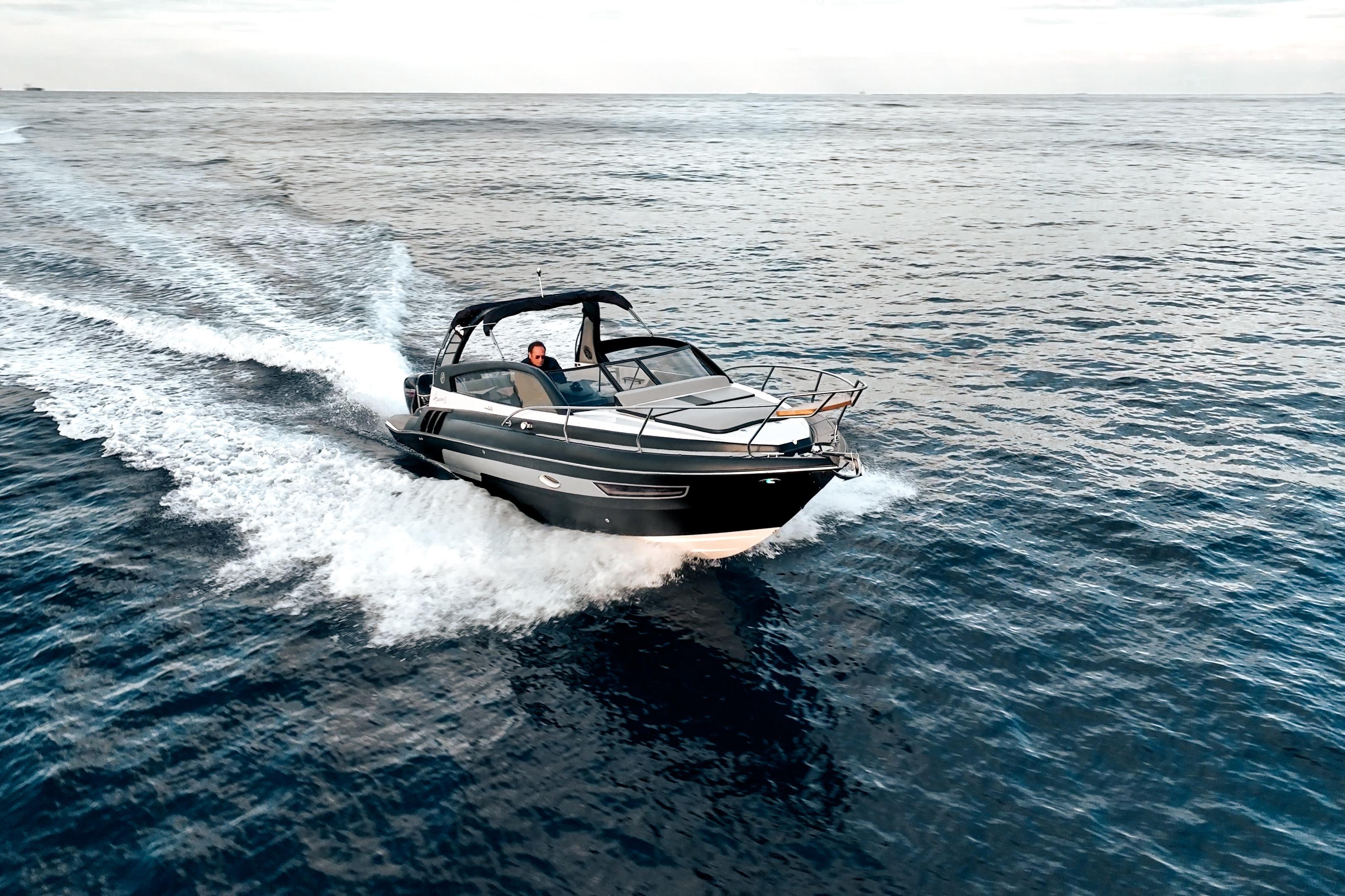 A 2027 Hanover 305 boat cruising swiftly on open water.