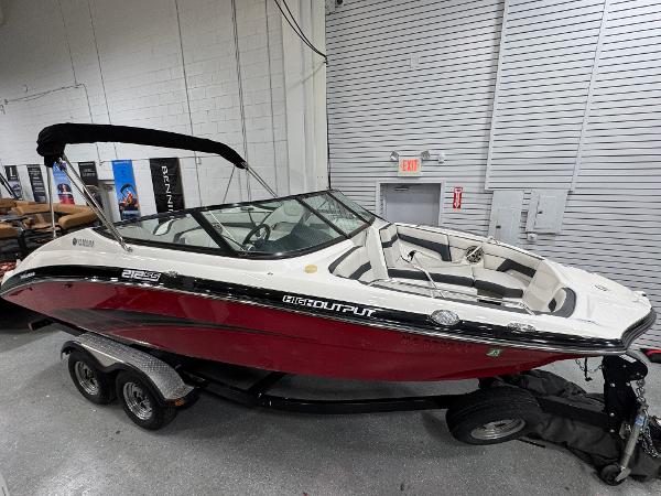 2014 Yamaha Boats 212X in showroom, red and white design, on trailer.