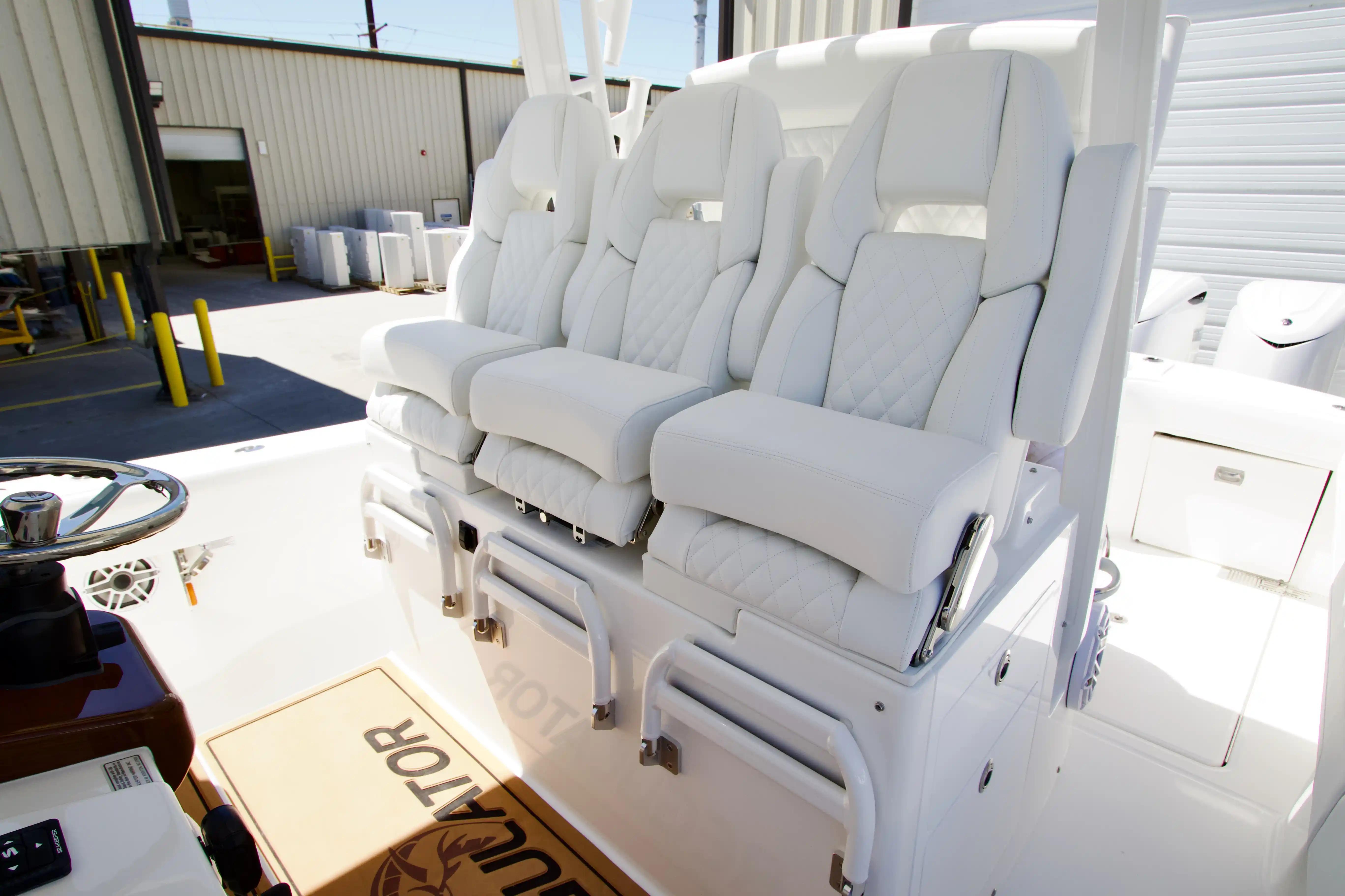 Luxury seating on 2027 Regulator 35 boat, featuring white cushioned captain chairs.