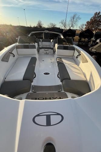 2024 Tahoe T21 boat interior with gray seating, open deck, and sunny background.