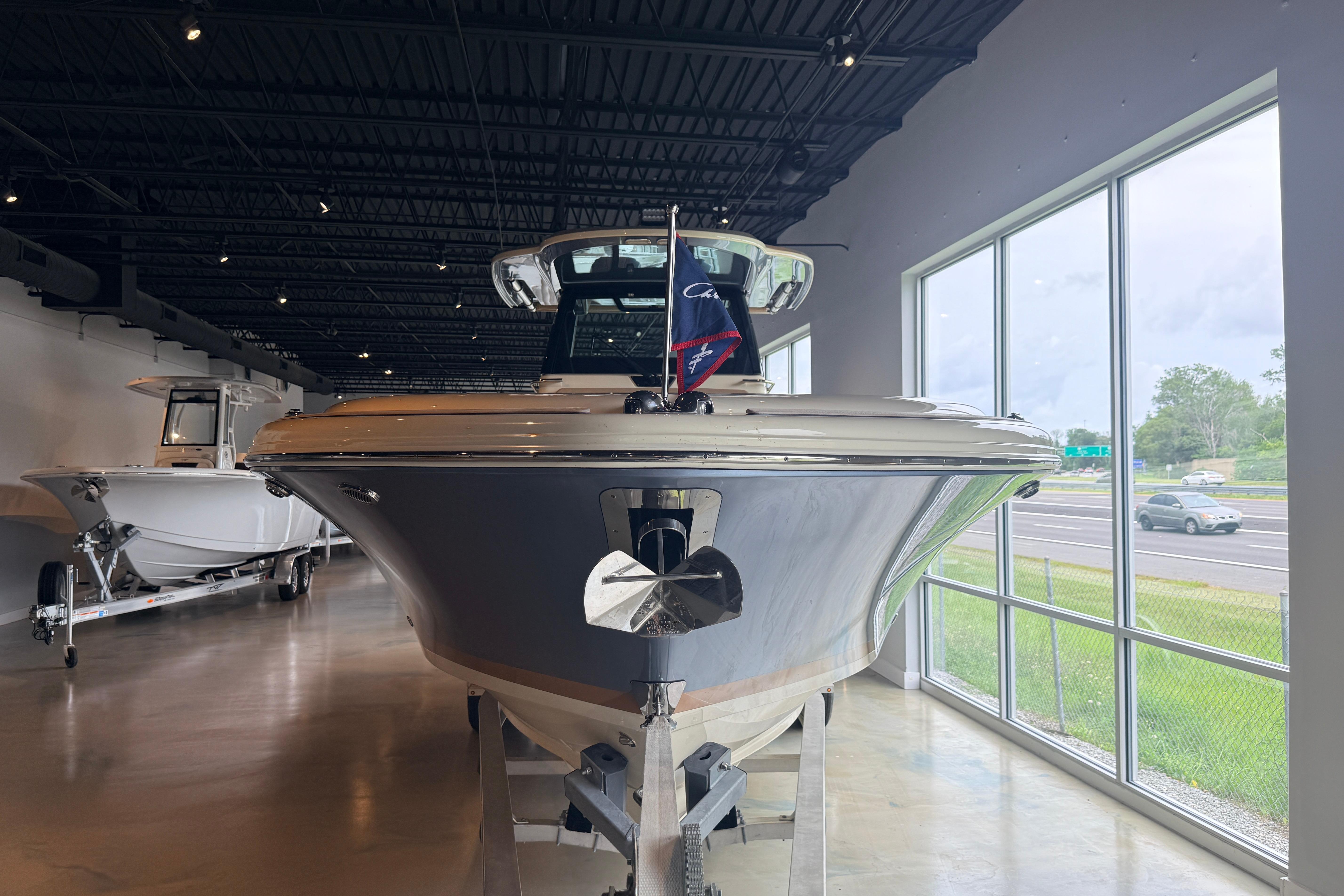 2024 Chris-Craft Catalina 30 boat displayed indoors, front view.