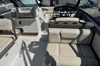 2019 Bryant Calandra 23 boat interior with beige seating and modern dashboard.