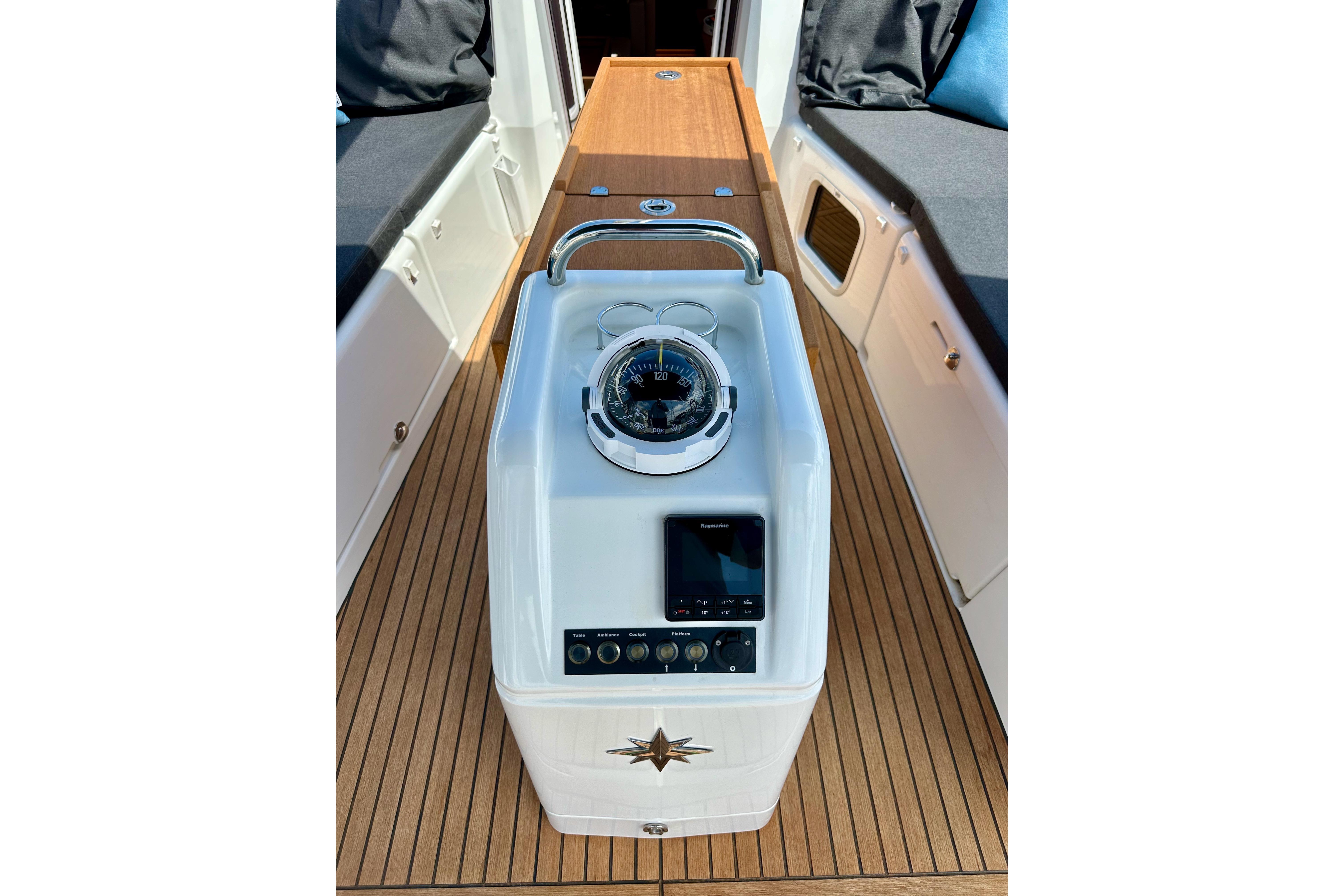 2024 Jeanneau Sun Odyssey 410 cockpit with compass and navigation controls.