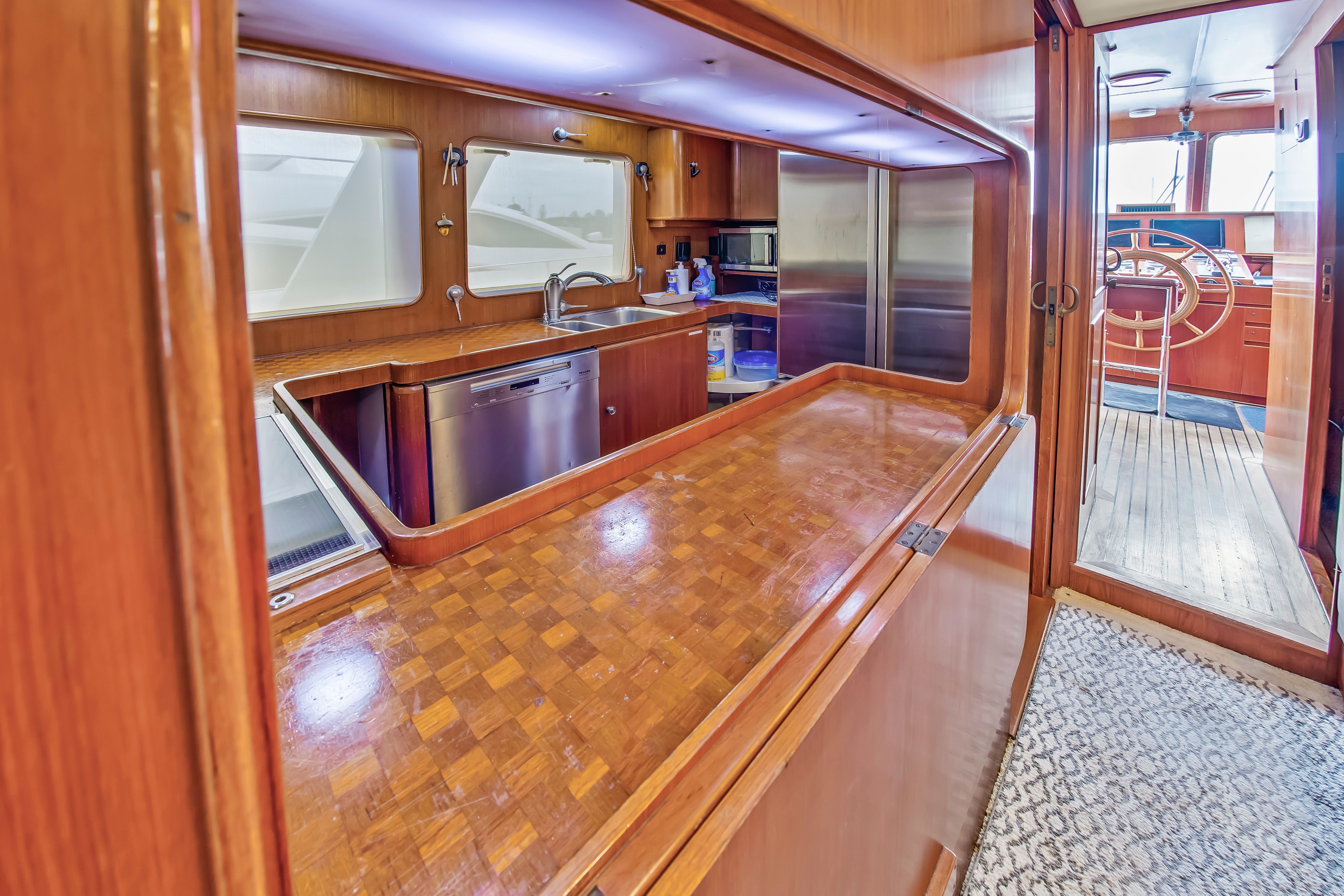 Interior of a 1987 Jongert 78 Motor Yacht featuring wood finishes and a modern kitchen.