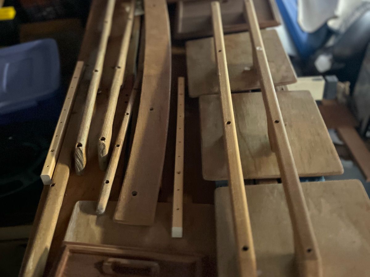 Wooden parts and planks, likely for boat construction or repair.