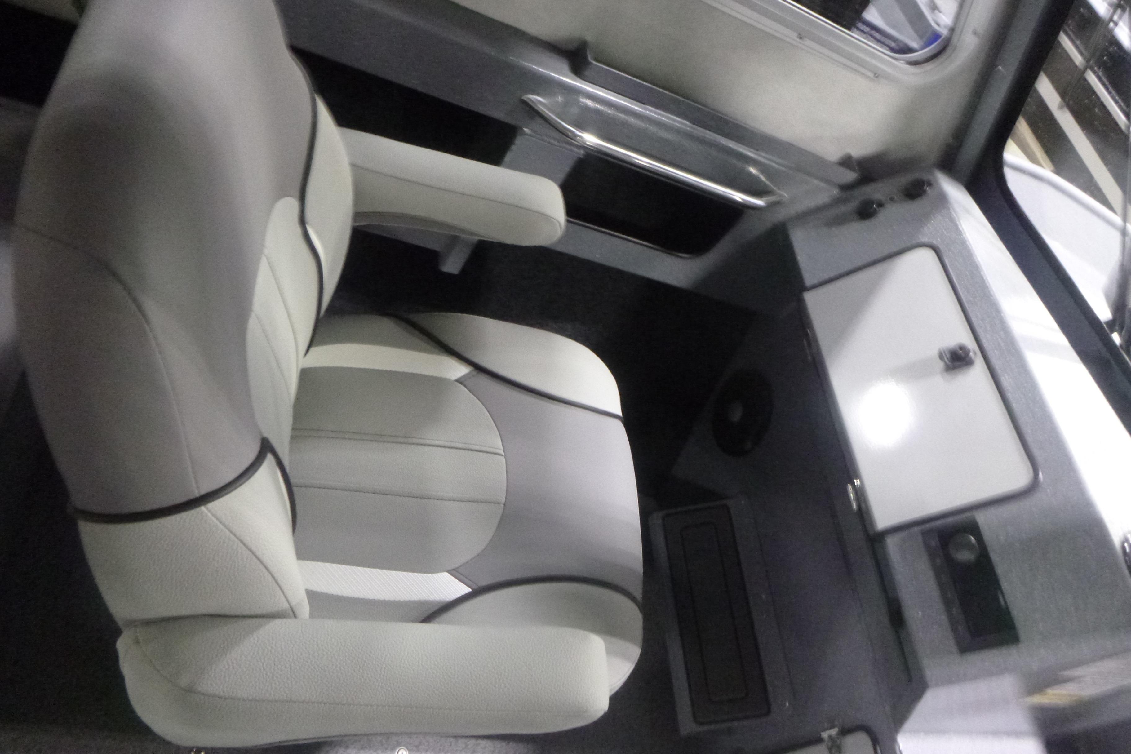 Interior of 2026 KingFisher 2425 Escape HT boat, featuring a comfortable captain's chair.