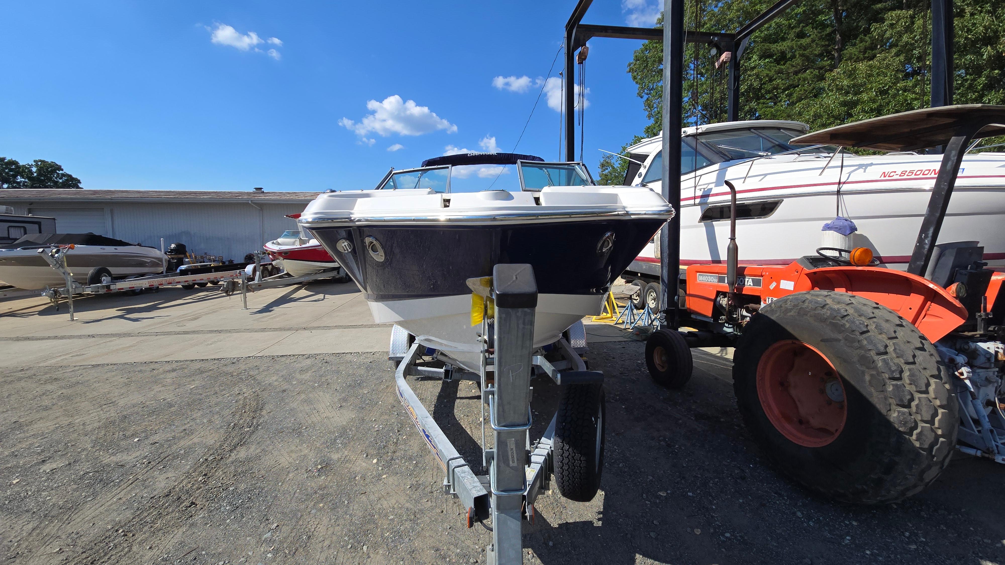 2018 Chaparral 224 Sunesta boat on trailer in outdoor storage area.