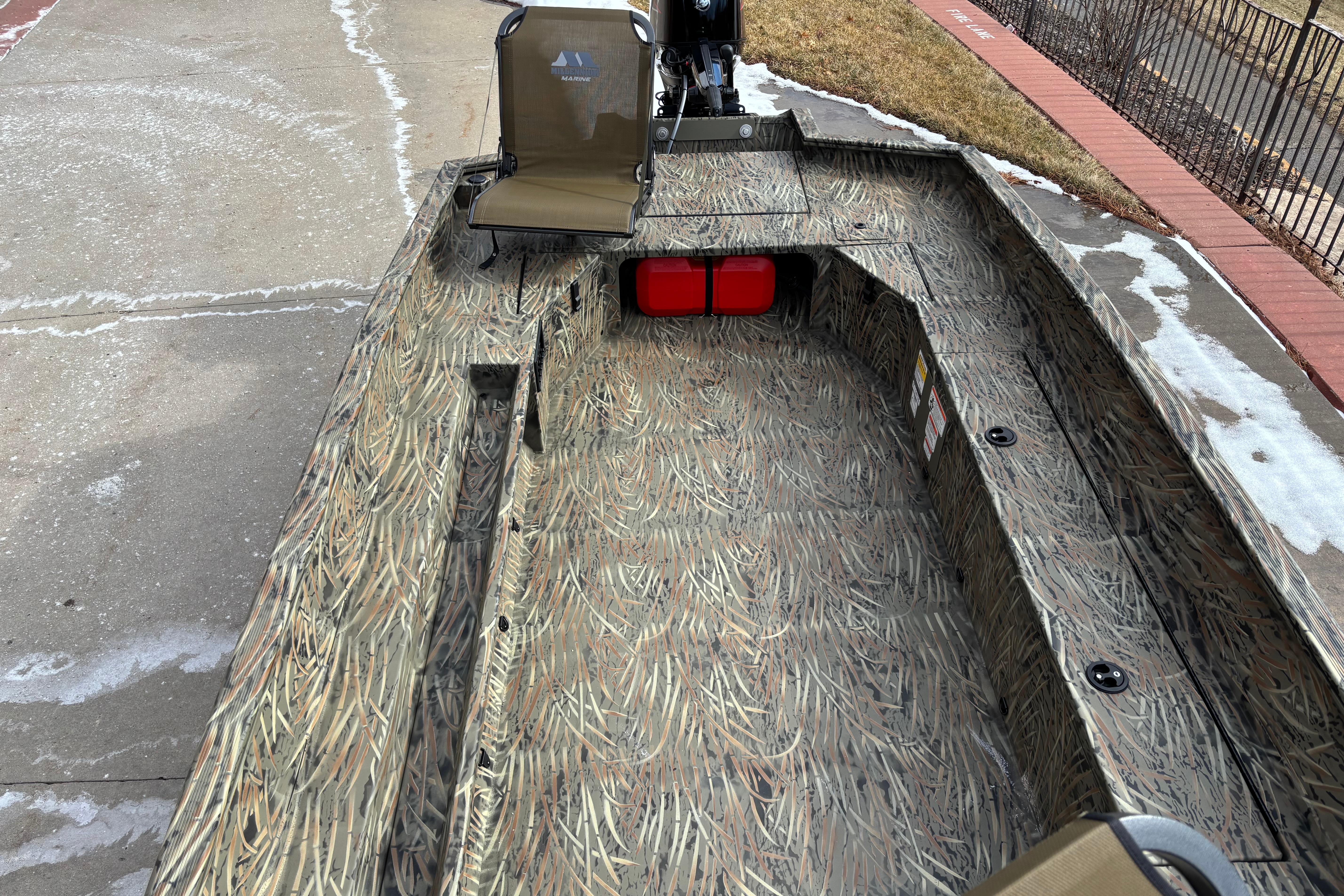 2026 Tracker Grizzly 1756 T Marsh boat with camouflage design on concrete surface.