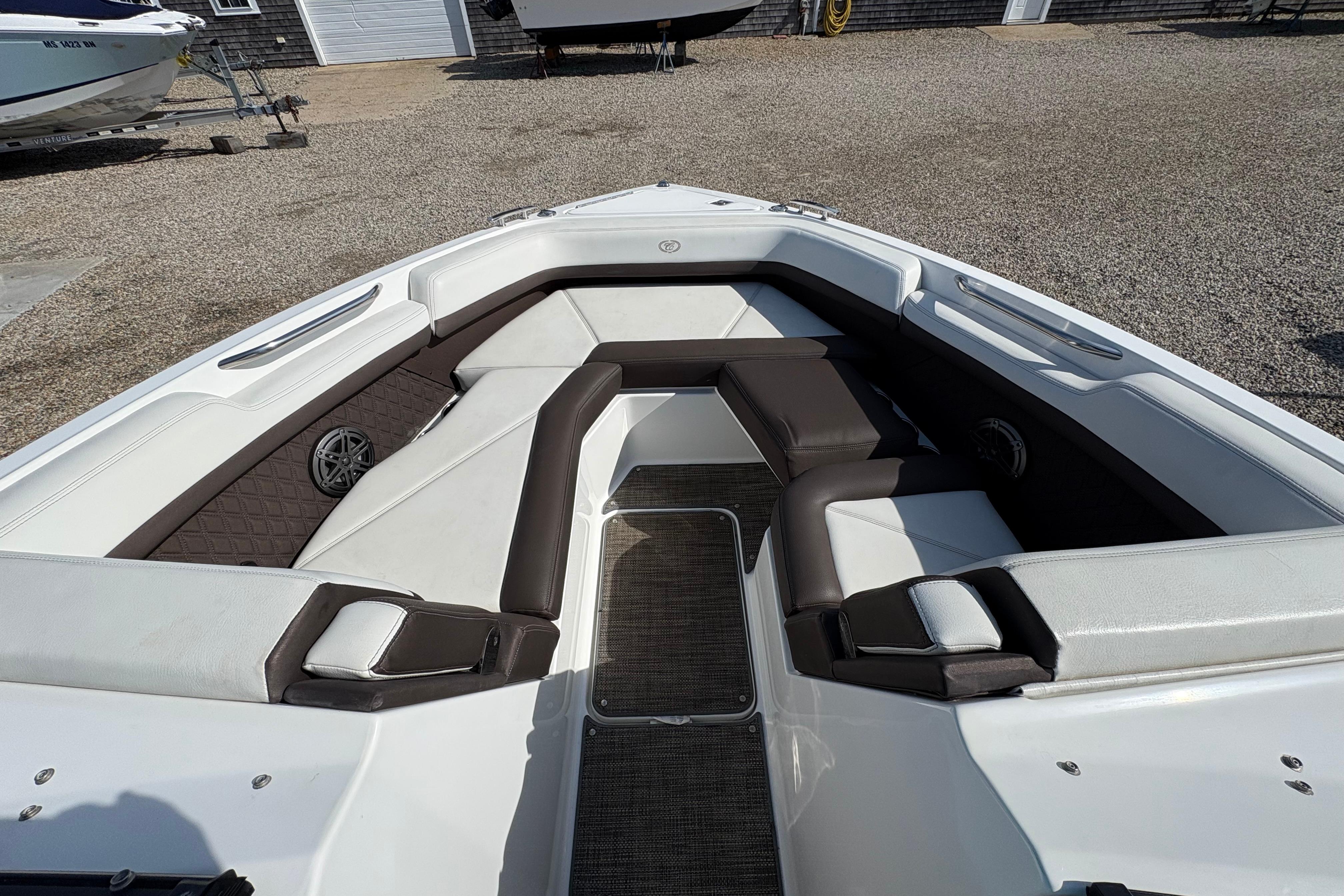 2022 Cobalt R6 boat interior with white and brown seating, outdoor setting.