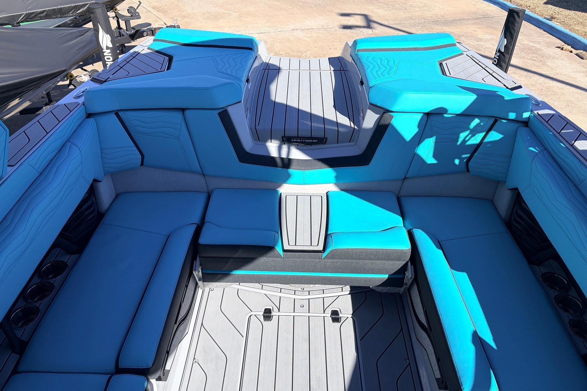Interior of 2026 Nautique Super Air Nautique G23 with blue seating and sleek design.