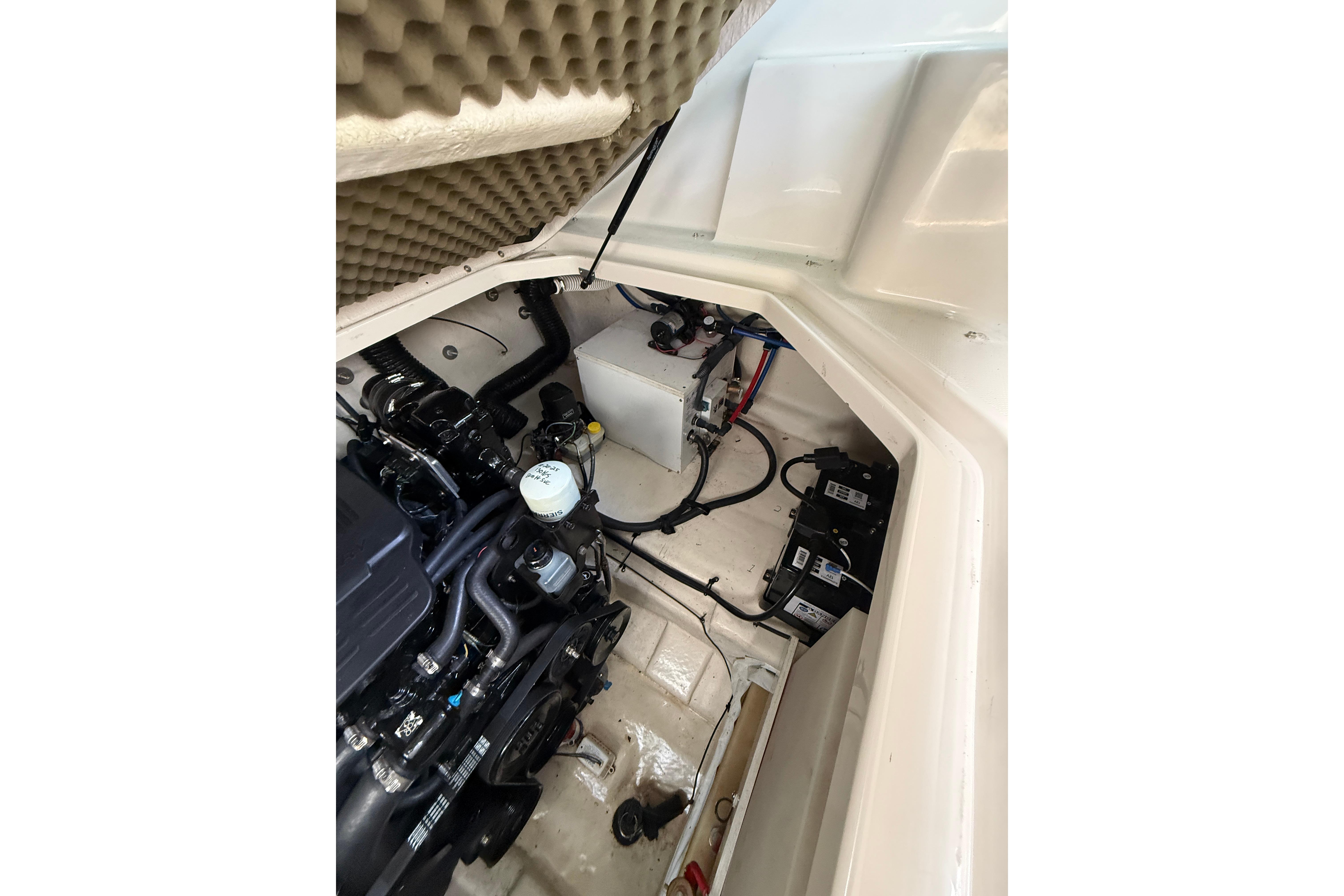 Engine compartment of a 2004 Sea Ray 240 Sundancer boat, showcasing mechanical components.