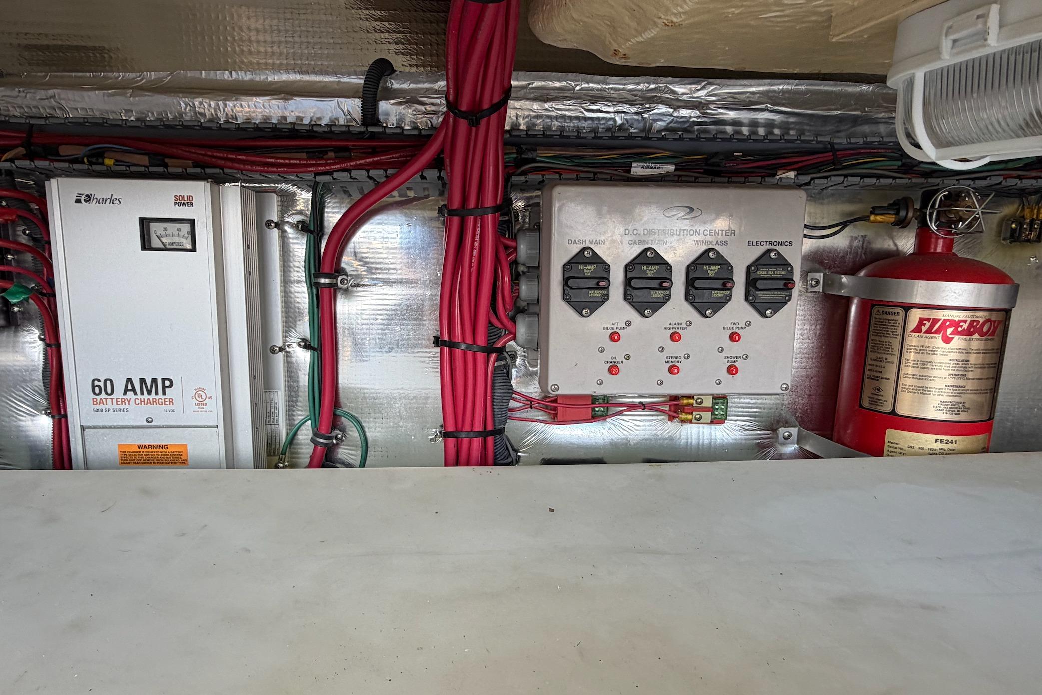 Electrical system of a 2006 Regal Commodore 3560 boat with battery charger and fire extinguisher.