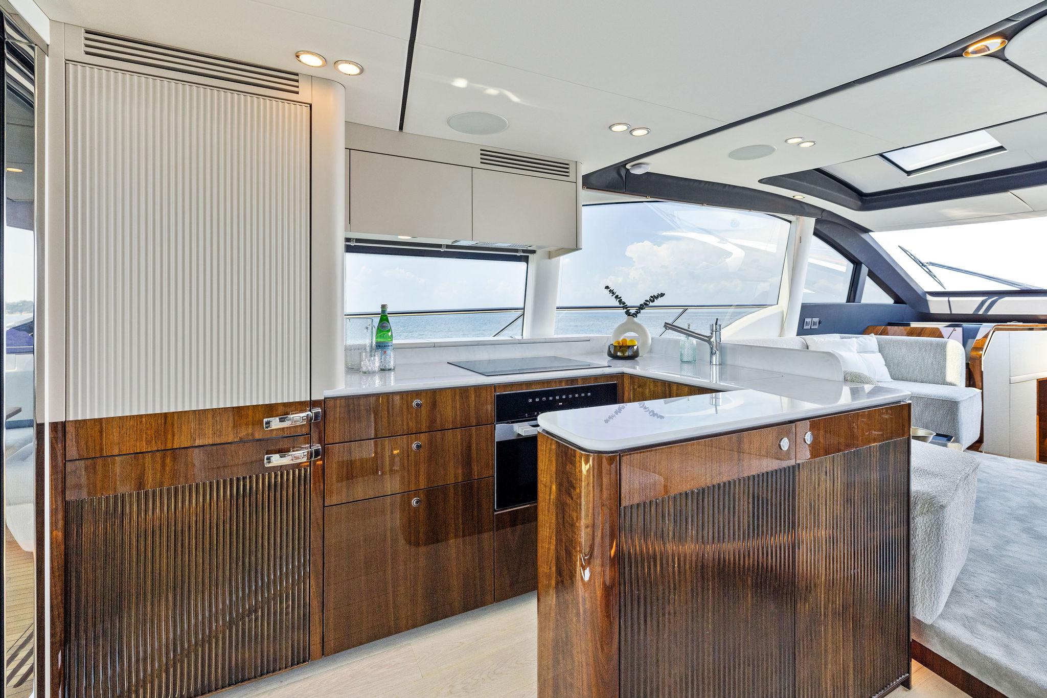 Luxurious interior of 2024 Fairline Phantom 65 yacht with modern kitchen design.