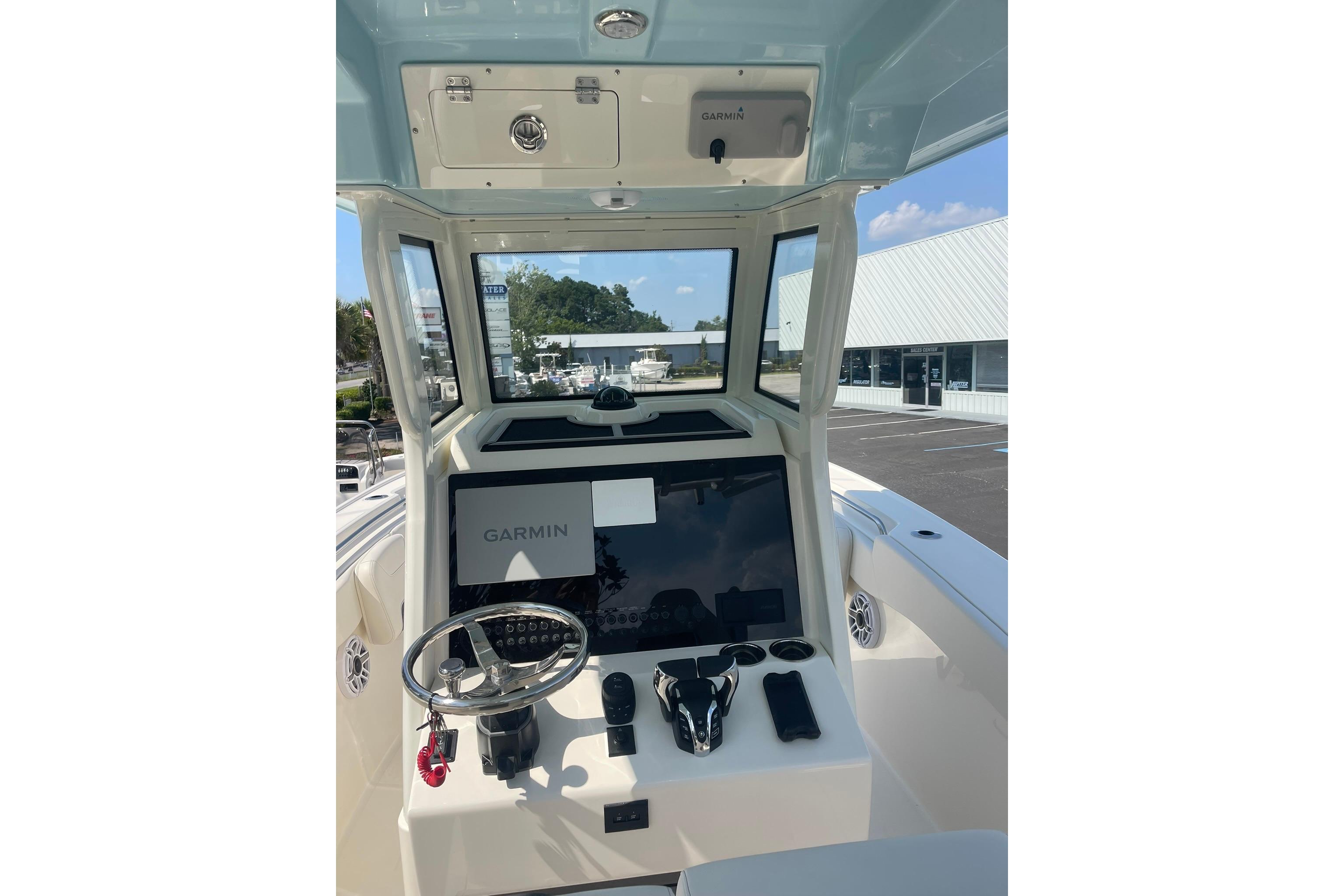 Helm of 2026 Pioneer 250 Pelagic boat with Garmin navigation system and steering wheel.