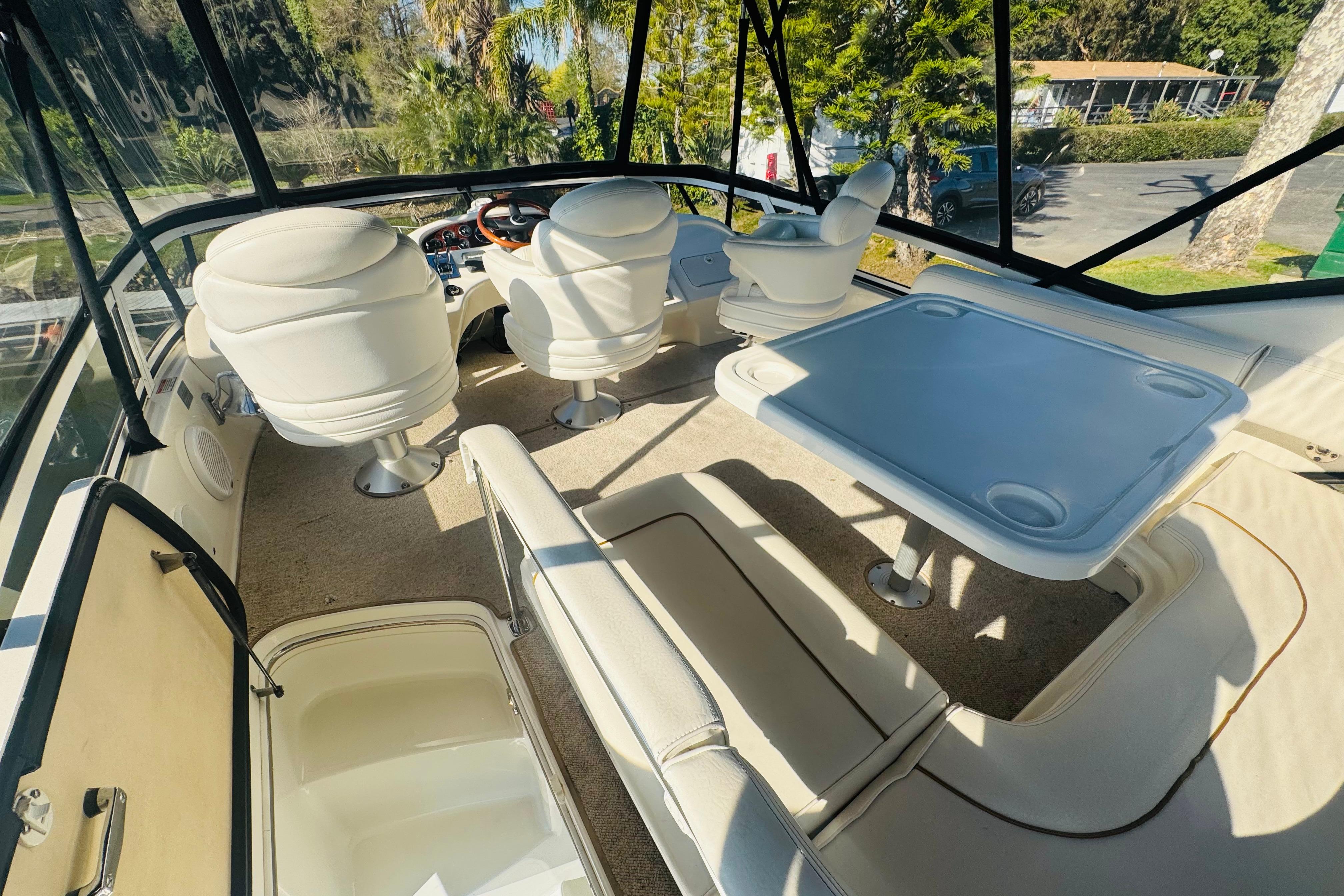 Interior view of 2000 Sea Ray 400 Sedan Bridge yacht with seating and table.