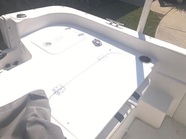 2011 Carolina Skiff 258 DLV boat deck, white surface, storage compartments visible.