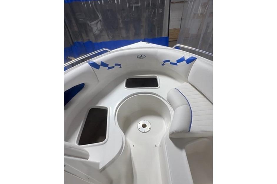 1999 Tide Craft Trophy Angler boat interior with white seating and blue accents.
