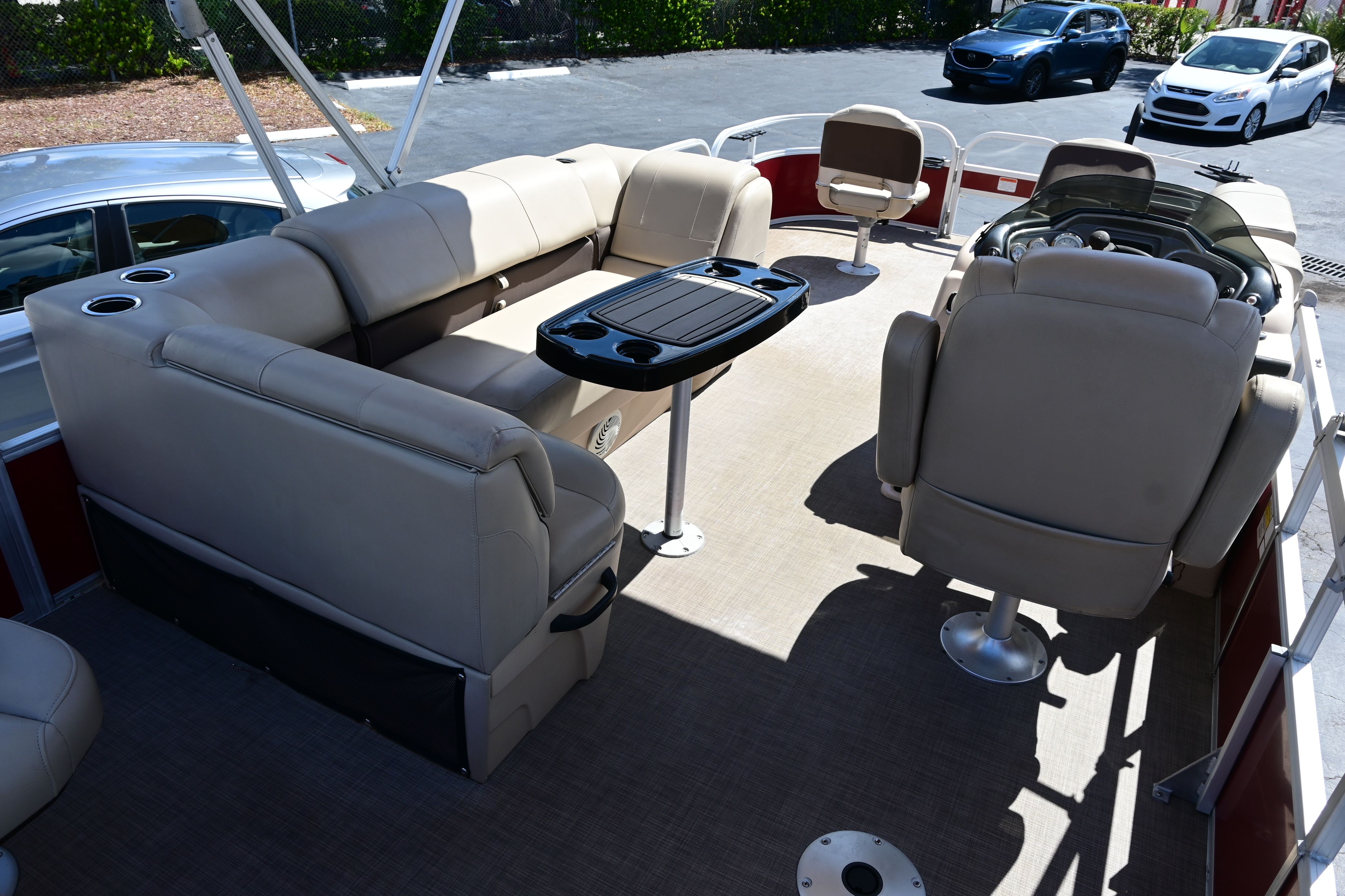 Interior of a 2019 Sun Tracker FISHI pontoon boat with beige seating.
