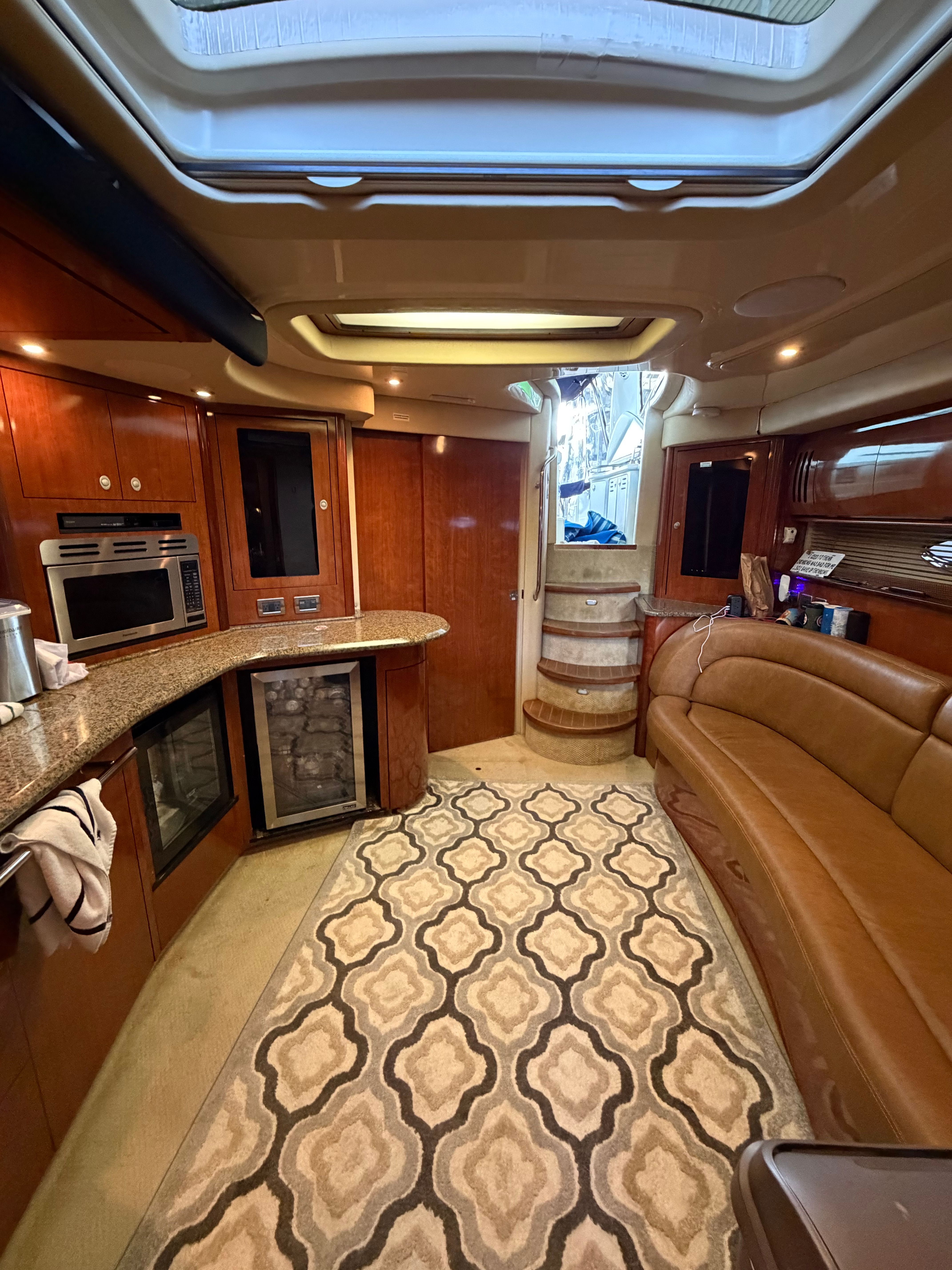 Interior of a 2005 Sea Ray 420DA with elegant kitchen and cozy seating area.