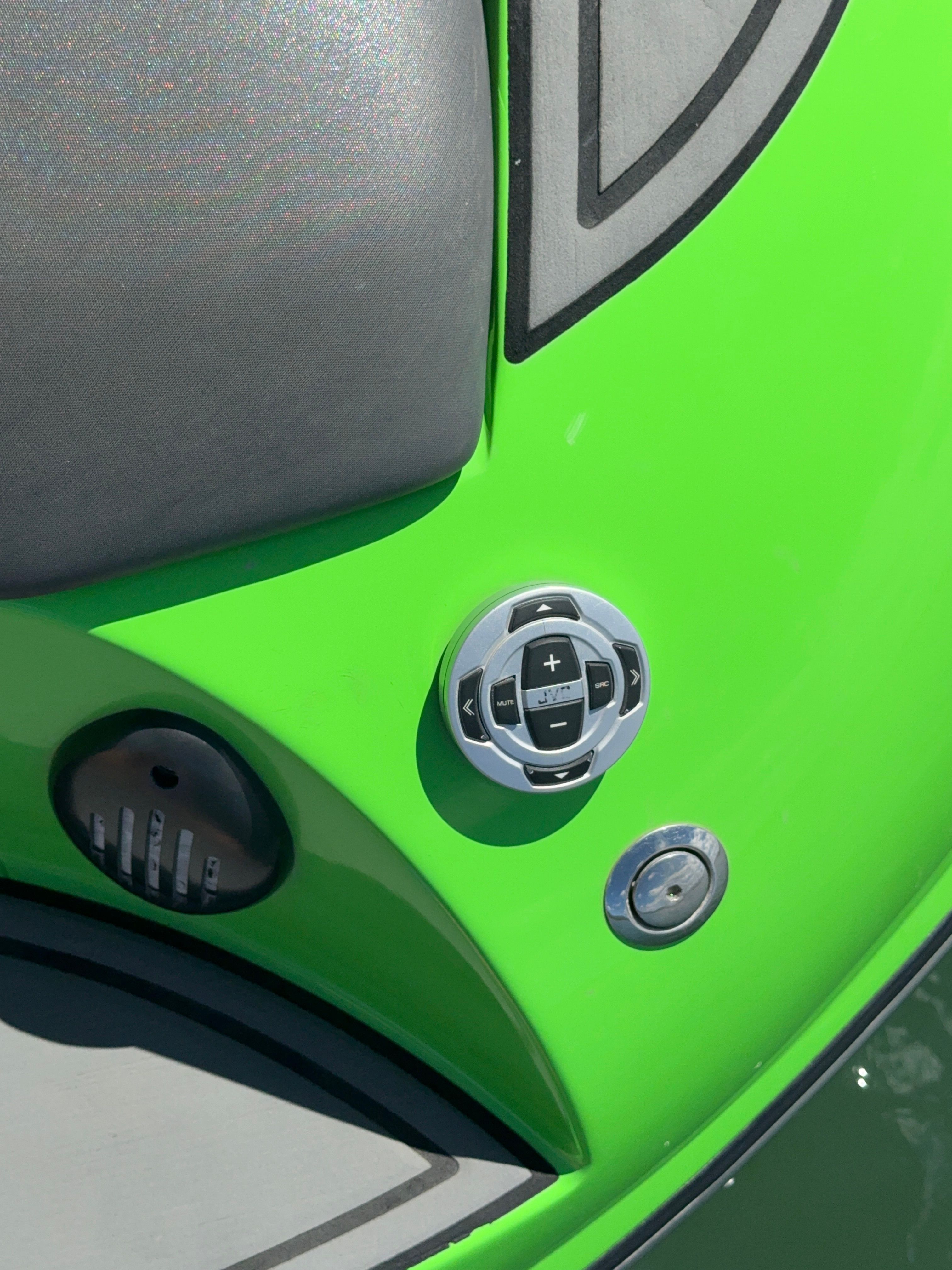 Close-up of a green boat section with controls and padding.