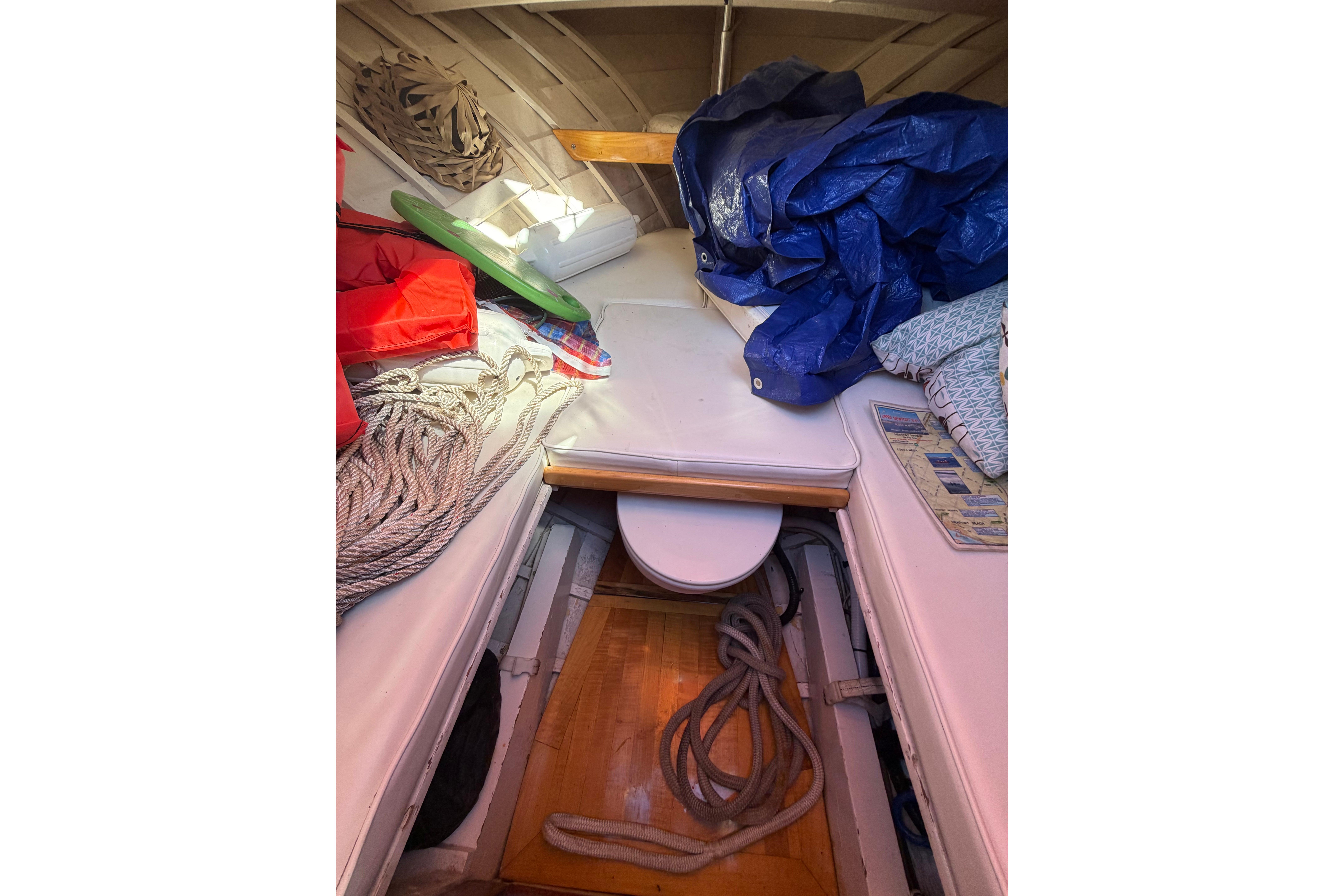 Interior of a 1964 Lyman 25 Sleeper boat with ropes and cushions.