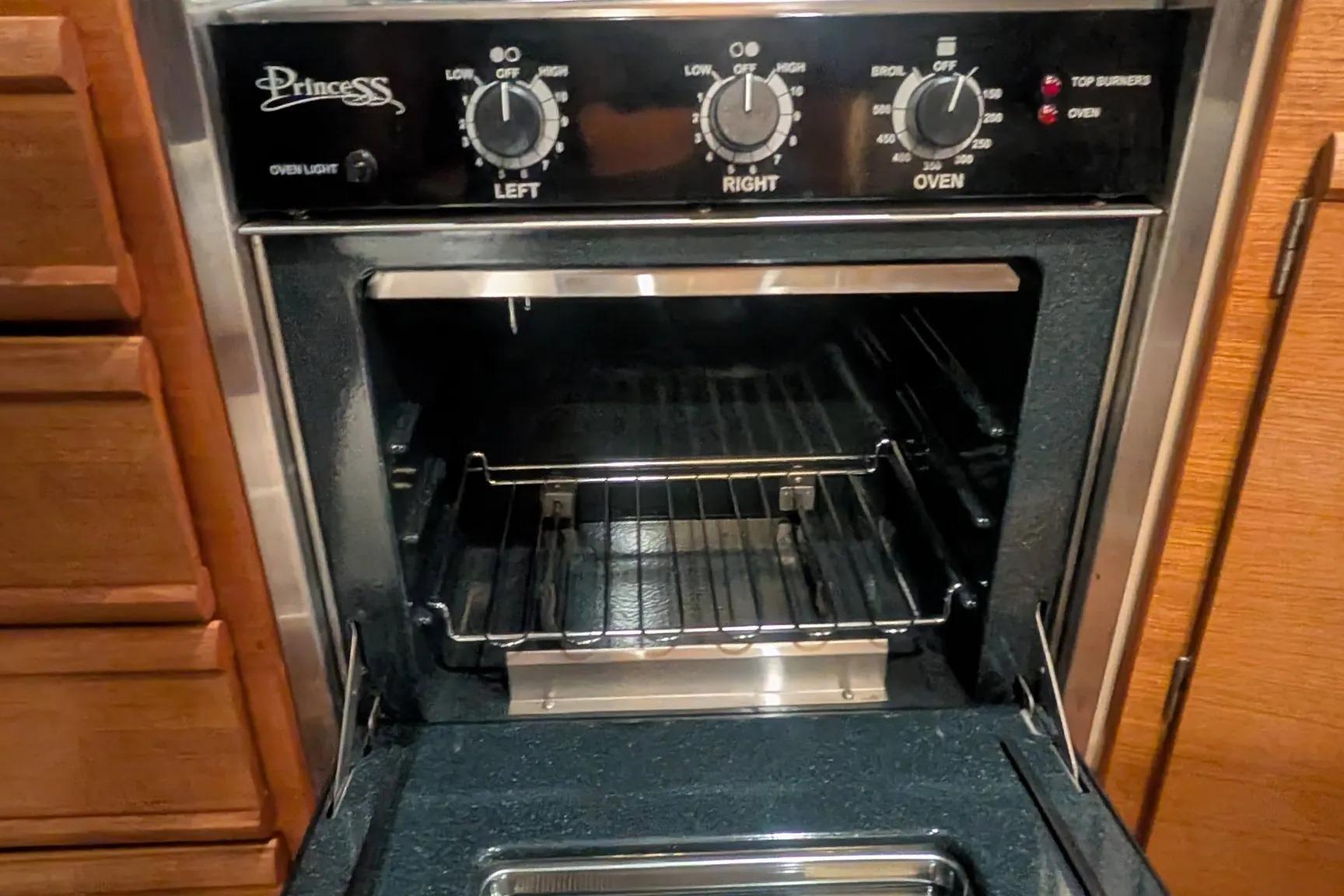 Princess oven in 2015 Ranger Tugs R-29 S boat kitchen, featuring control knobs and open door.