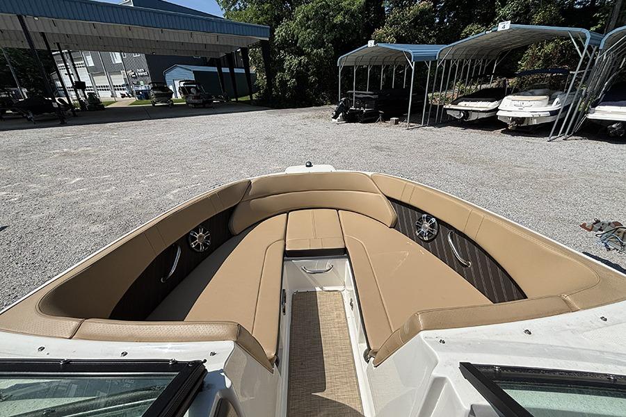 2019 Sea Ray SPX 230 Outboard boat with tan seating in a storage area.