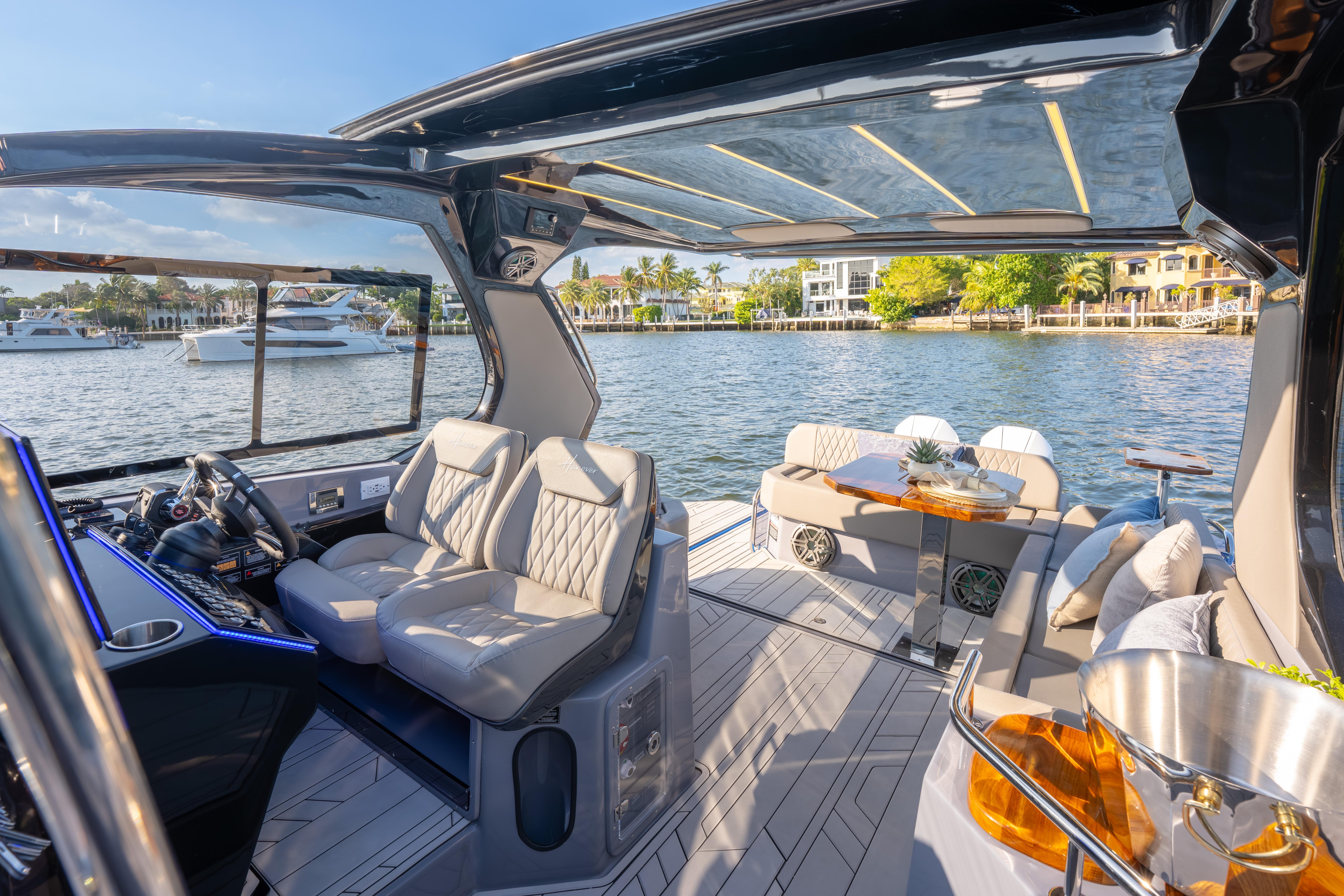 Luxurious 2026 Hanover 347 yacht interior with plush seating and elegant design on a sunny day.