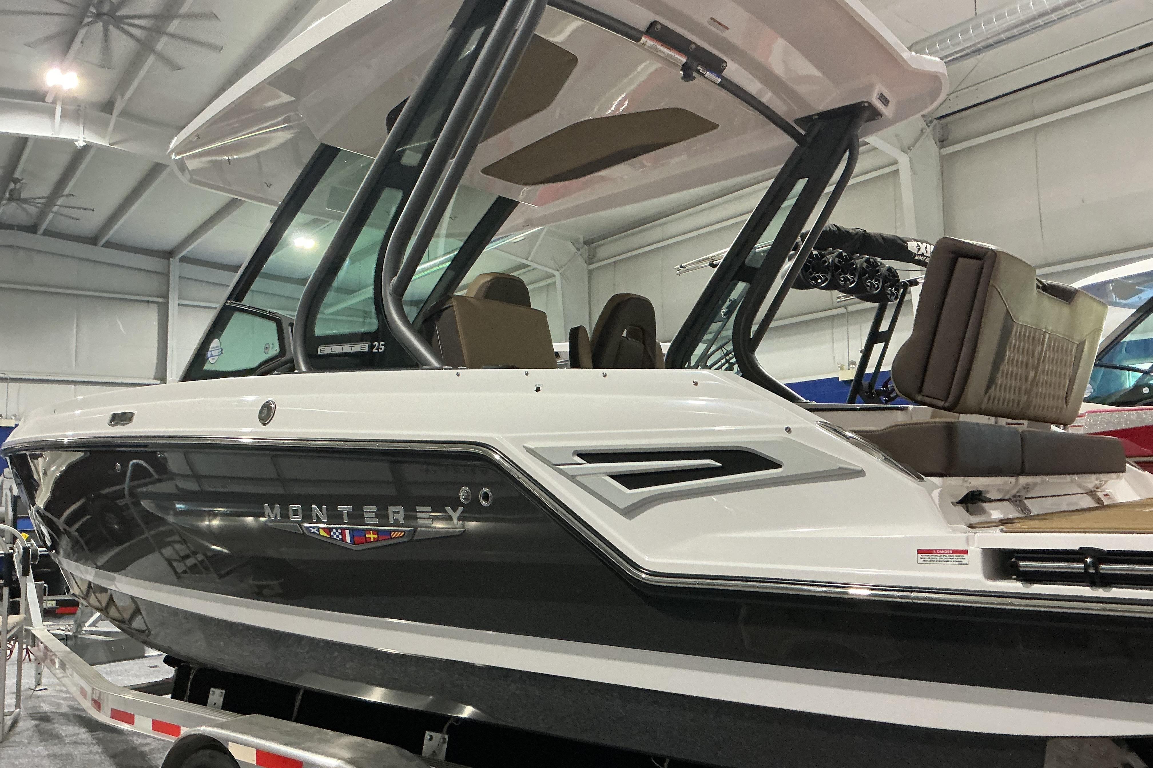 2026 Monterey Elite 25 OB boat displayed indoors, showcasing sleek design and modern features.