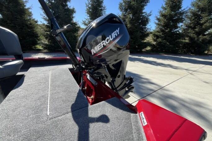 2025 Tracker Super Guide V-16 T boat with Mercury outboard motor, parked outdoors.