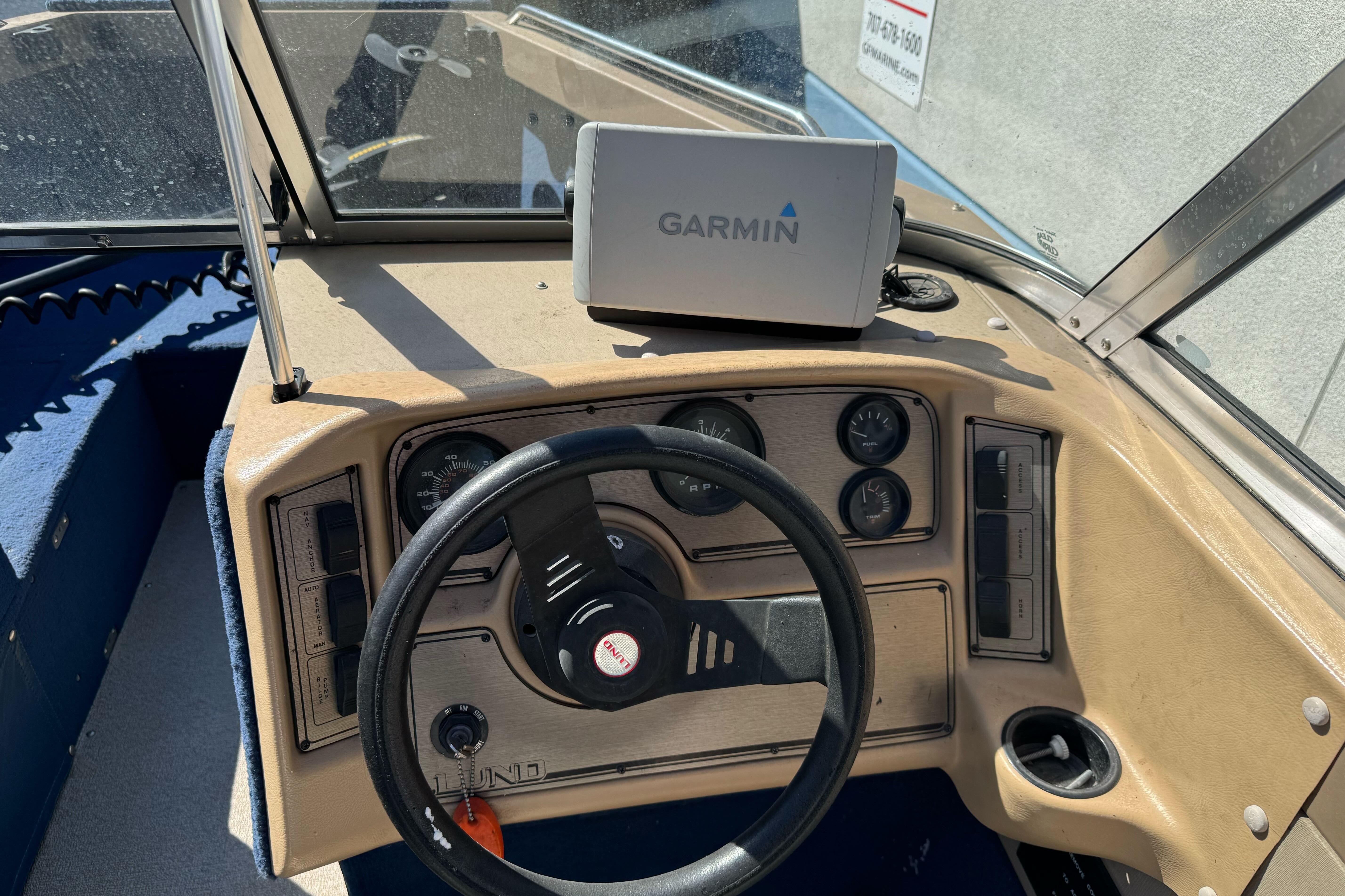 Dashboard of a 1998 Lund 1700 Pro Sport boat with Garmin navigation system.