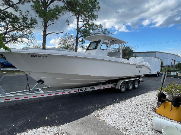 2014 Everglades 325 Center Console boat on trailer, parked outdoors.