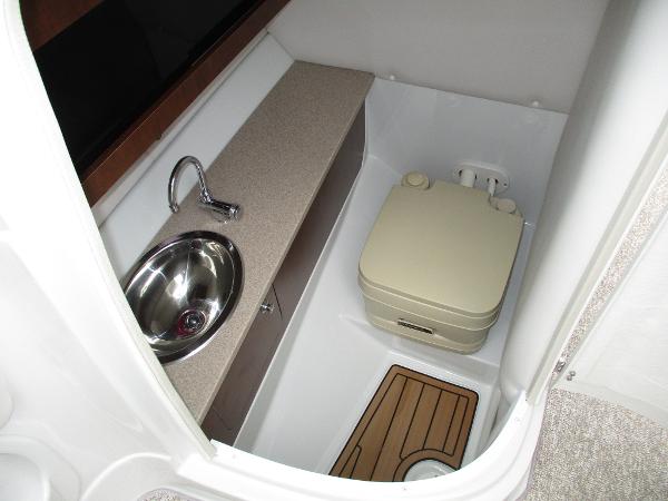 Interior of 2015 Crownline 285 SS with sink and toilet.