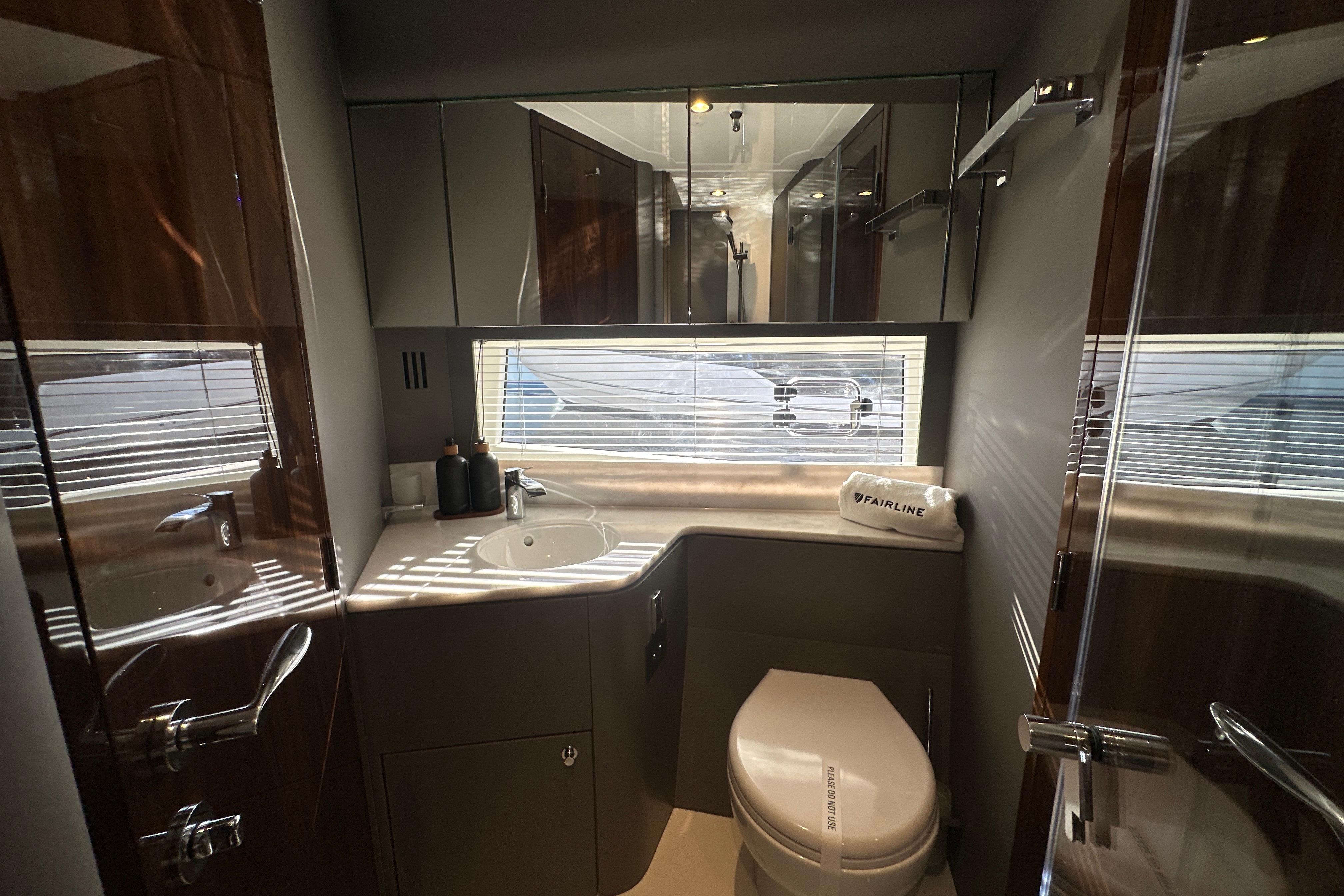 Luxurious bathroom interior of 2026 Fairline Targa 47 GT yacht, featuring modern fixtures and elegant design.