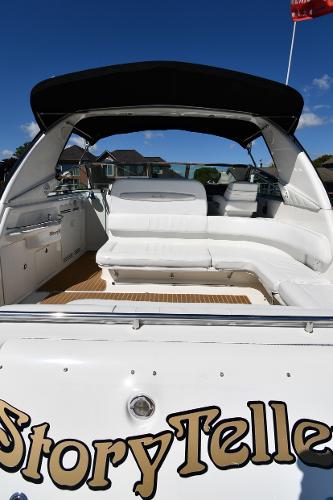 1997 Sea Ray 400 Sundancer boat with spacious seating and canopy, named "StoryTeller."