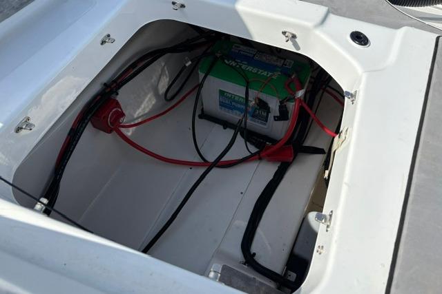 2024 Tahoe T21 boat battery compartment with wiring and connections.