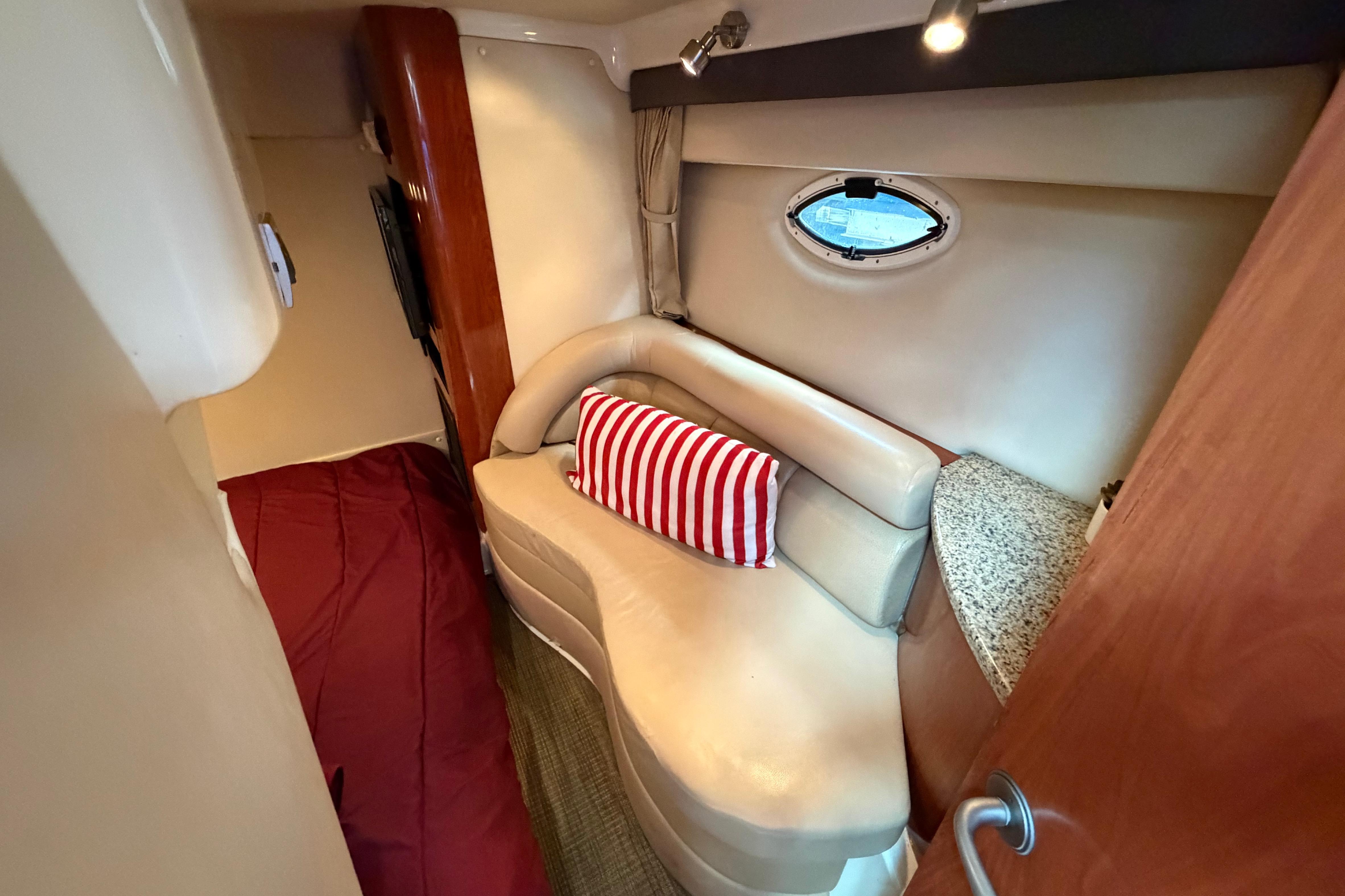 Interior of 2007 Monterey 350 Sport Yacht with cozy seating and striped pillow.