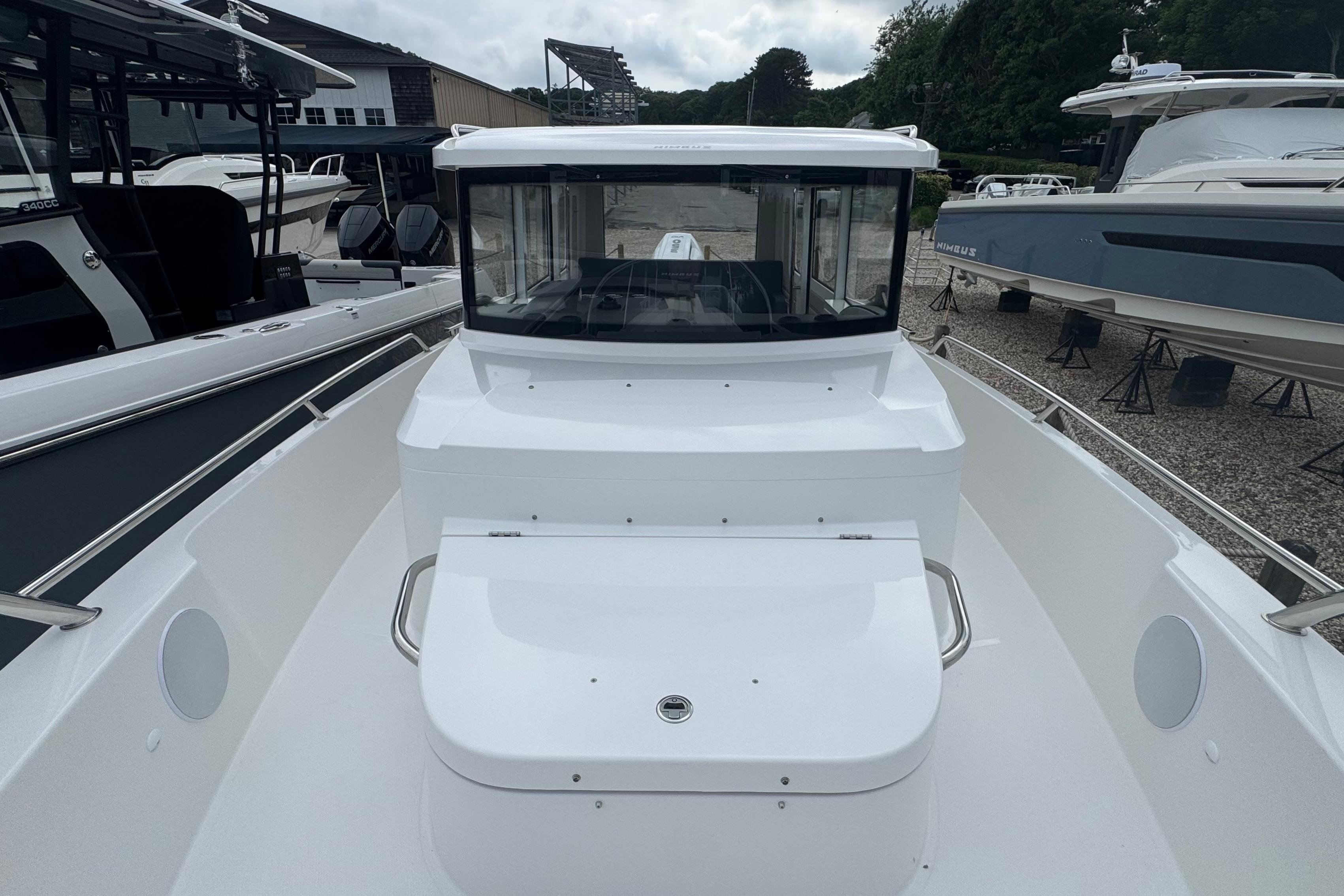 The image shows a 2026 Nimbus Commuter 9 boat parked on land.