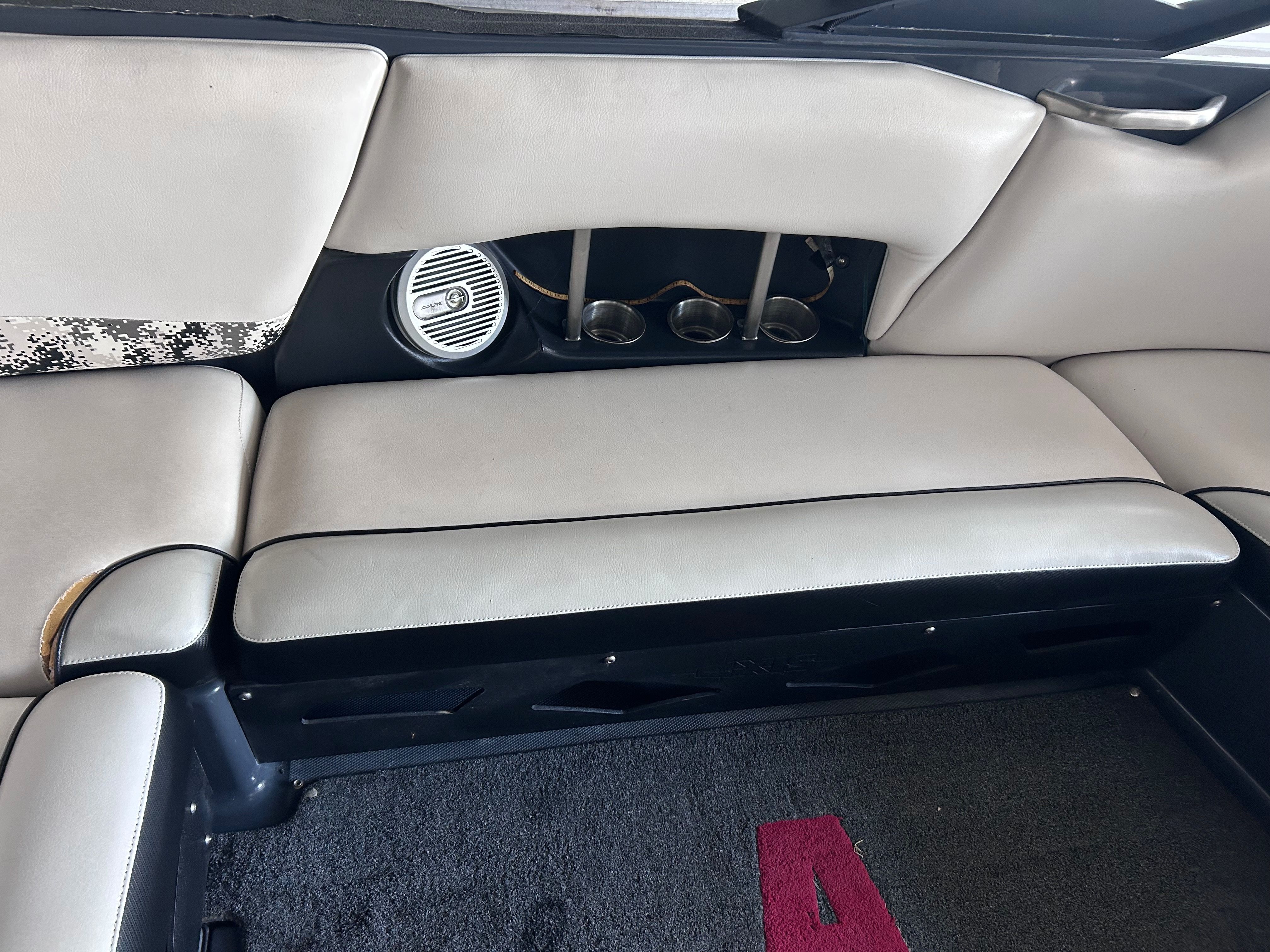 Interior of a 2013 Axis A22 boat with speaker and cup holders.