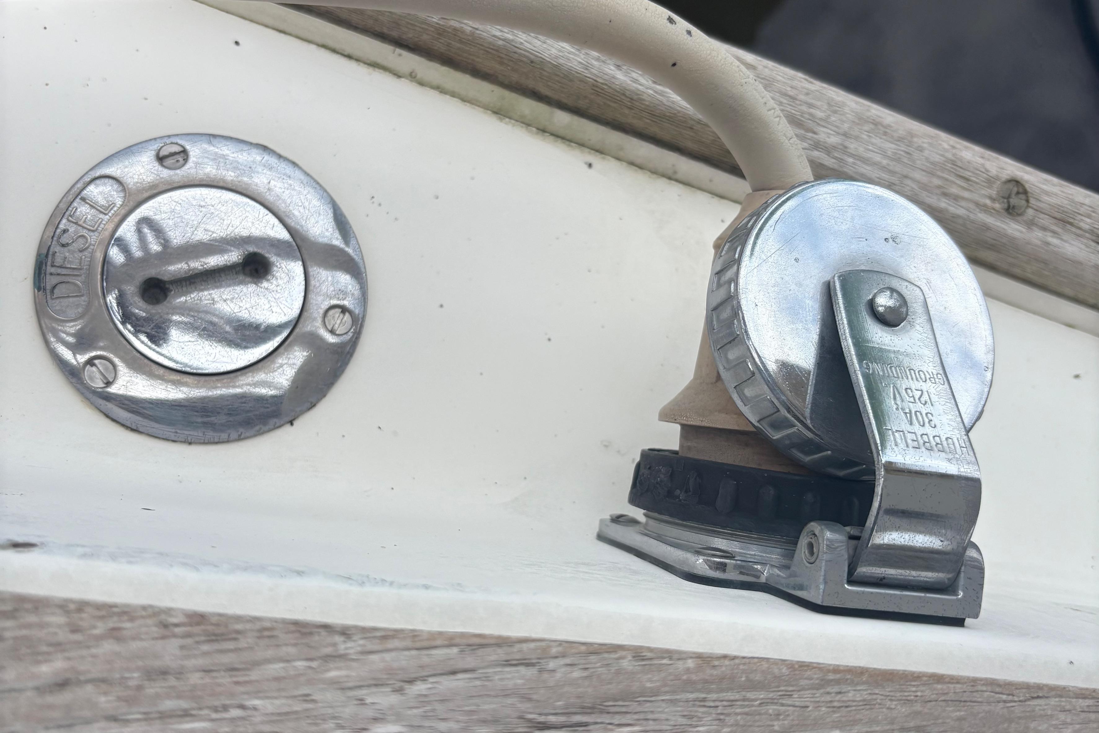 1981 Sabre 31 boat diesel fuel cap and power connector on deck.