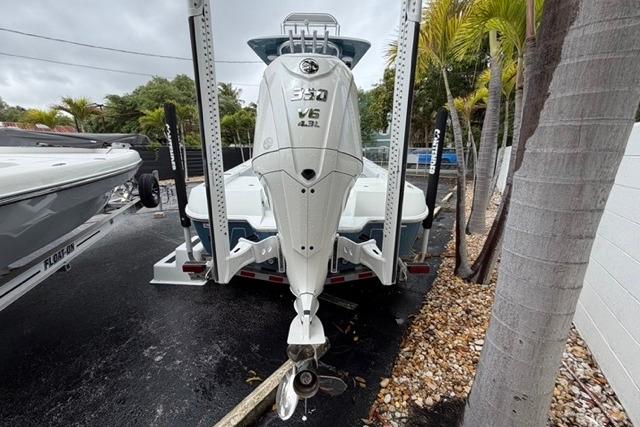2025 Contender 26 Bay boat with powerful outboard motor, parked outdoors.